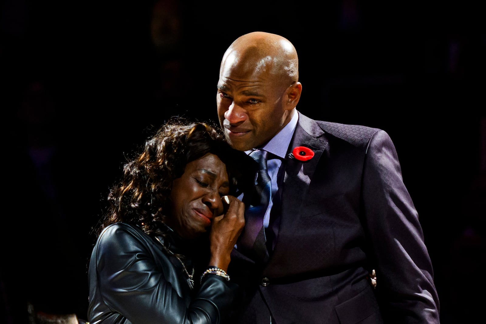 Former Toronto Raptors player Vince Carter reacts while hugging his mother, Michelle Carter, during his number retirement ceremony at halftime of an NBA basketball game between the Toronto Raptors and the Sacramento Kings in Toronto on Saturday, Nov. 2, 2024. (Christopher Katsarov/The Canadian Press via AP)