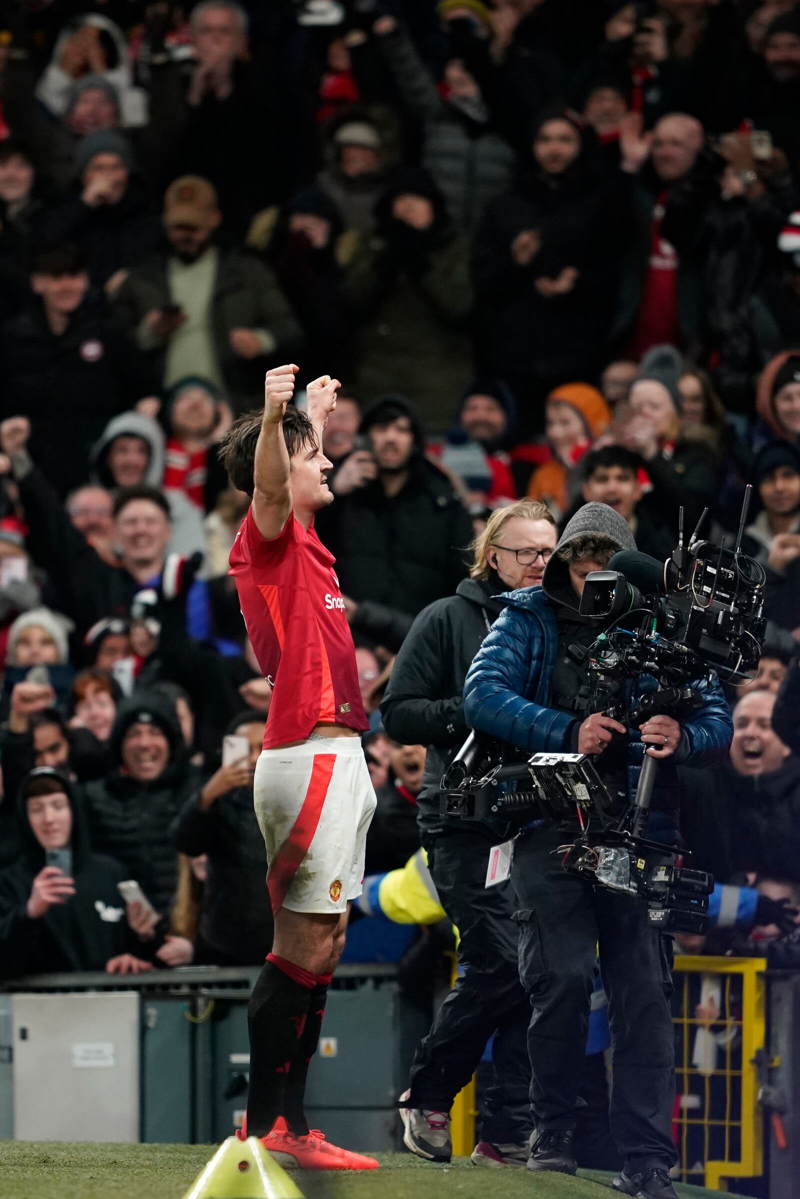 Manchester United's Harry Maguire celebrates after scoring his side's second goal during the English FA Cup fourth round soccer match between Manchester United and Leicester City at the Old Trafford stadium in Manchester, England, Friday, Feb. 7, 2025. (AP Photo/Dave Thompson)