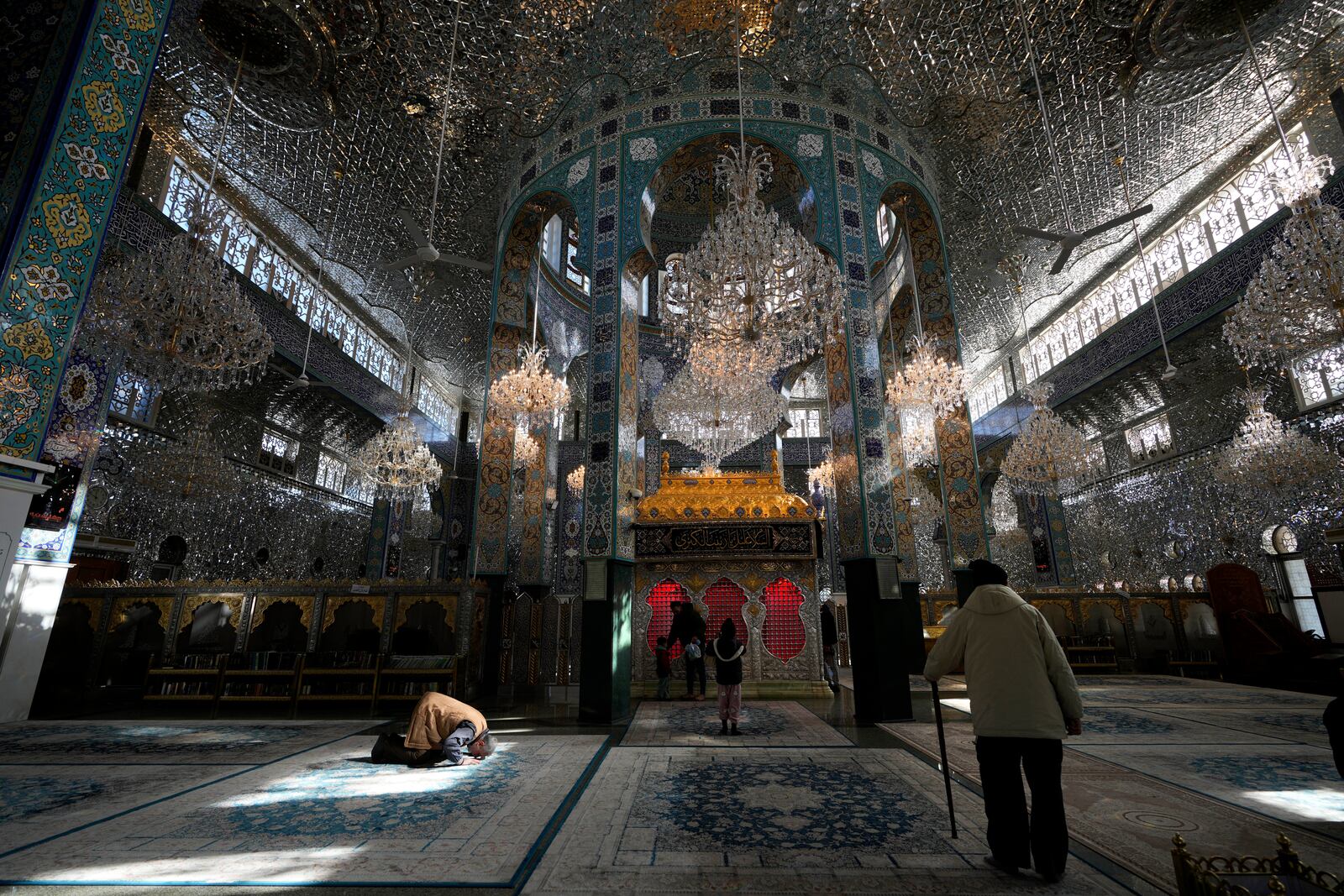 Syrians pray at the shrine of al-Sayydah Zeinab, the grand daughter of Prophet Mohammed, south of Damascus, Syria, Wednesday, Dec. 18, 2024. (AP Photo/Hussein Malla)