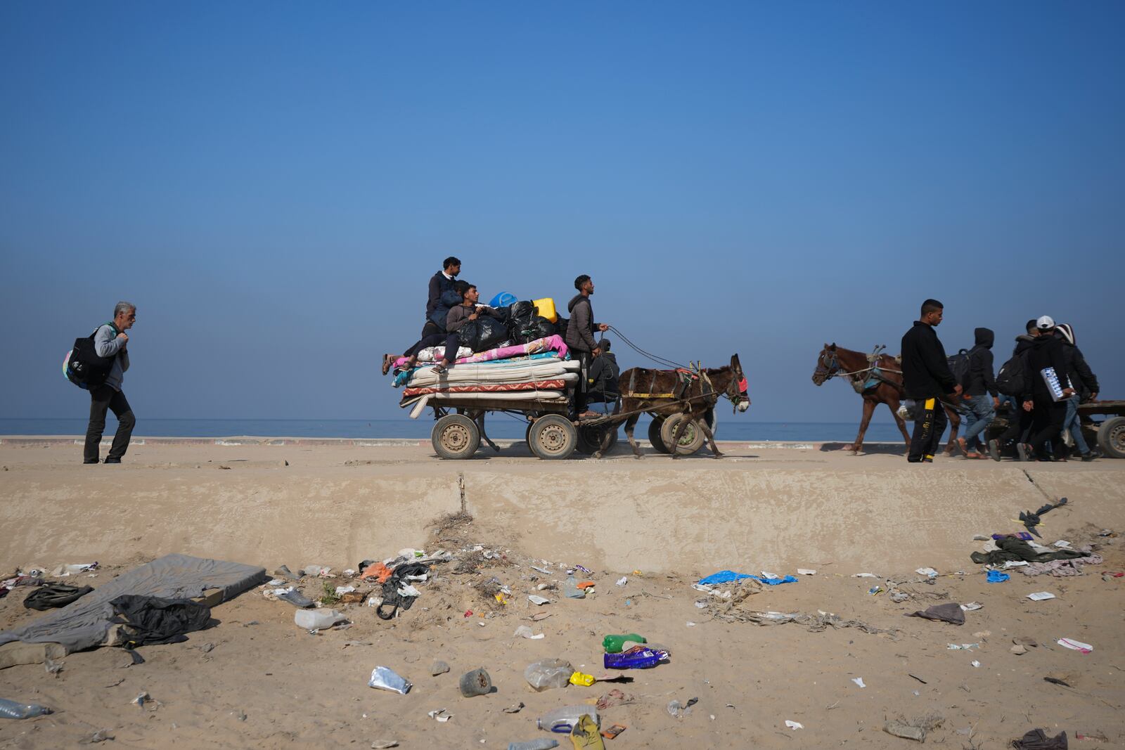 Displaced Palestinians walk on a road in central Gaza to return to their homes in the northern Gaza Strip, Wednesday, Jan. 29, 2025. (AP Photo/Abdel Kareem Hana)