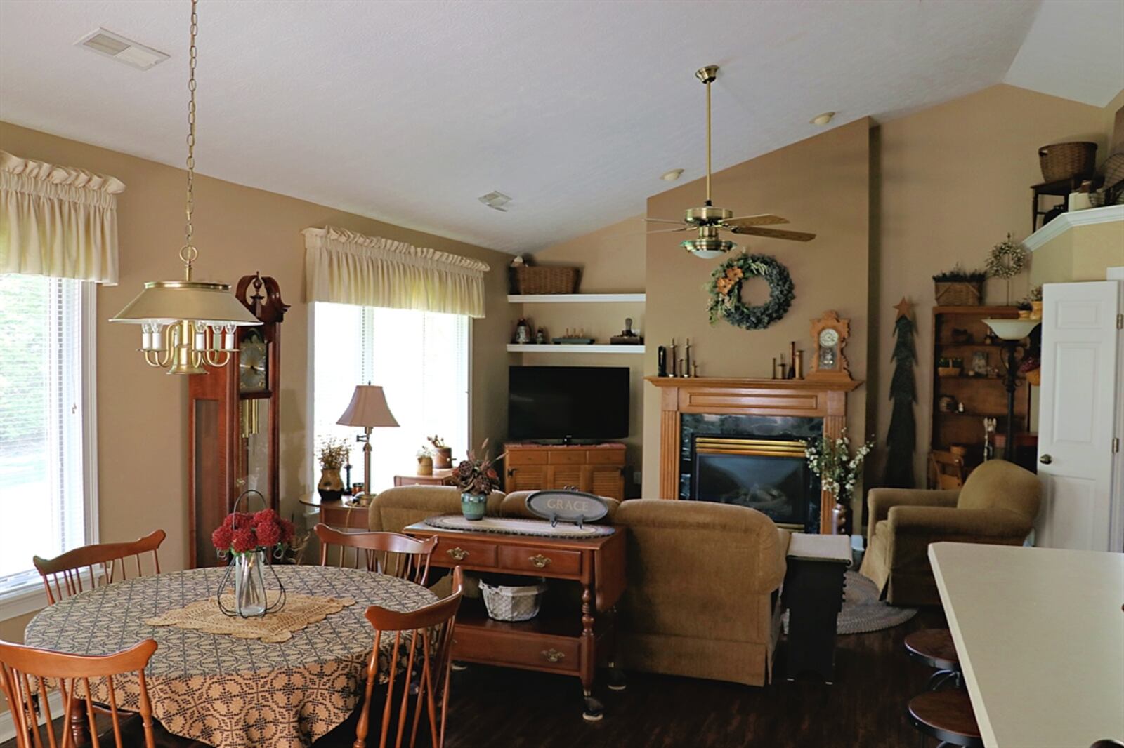 The cathedral ceiling peaks above the combined living room and dining room area.