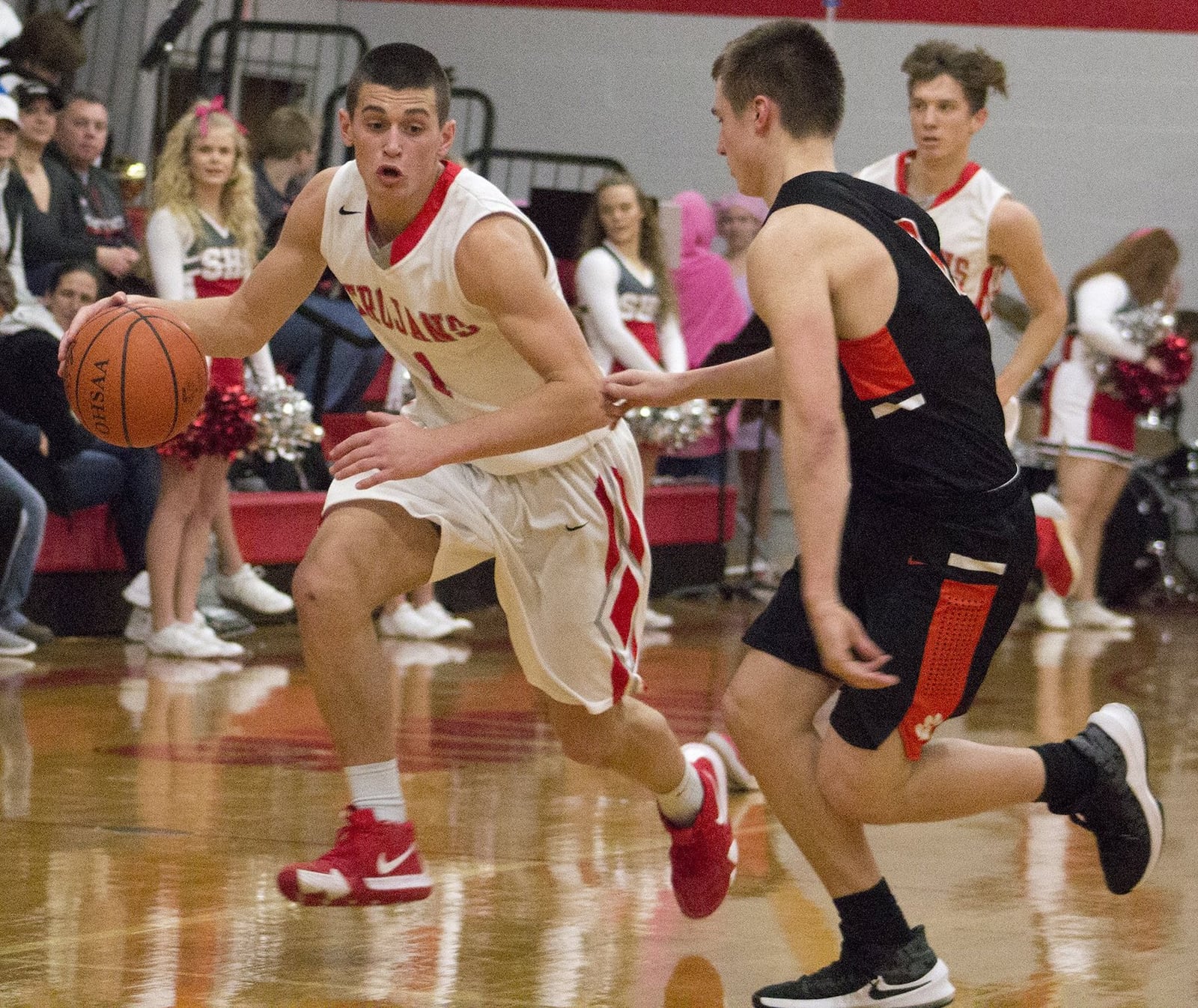 Southeastern’s Charlie Bertemes is guarded by West Liberty-Salem’s Nick Burden during Southeastern’s 66-58 victory Friday night. Bertemes led the Trojans with 22 points. Jeff Gilbert/CONTRIBUTED