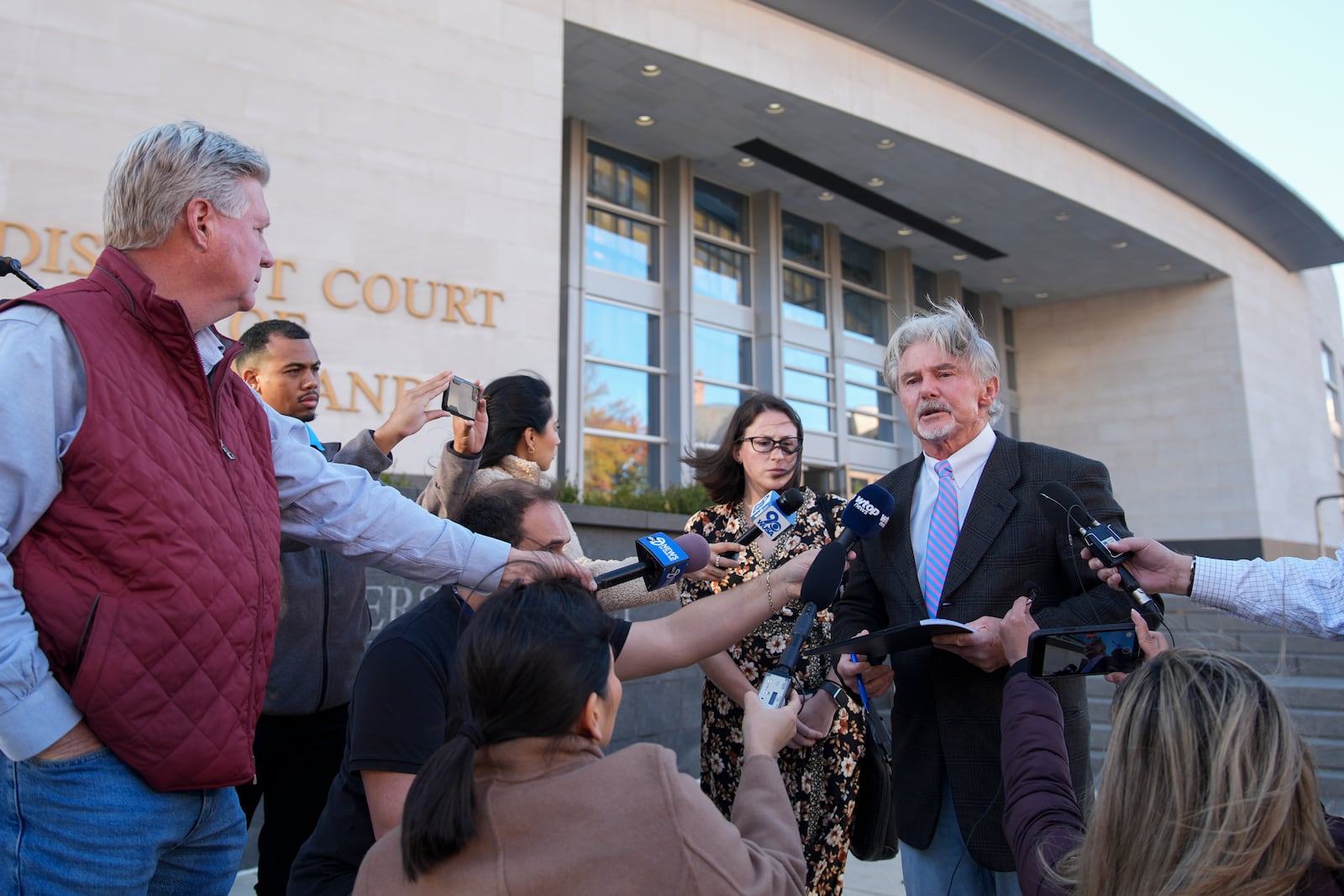 John McCarthy, state's attorney for Montgomery County, right, speaks to reporters outside of the Montgomery County District Court in Rockville, Md., Tuesday, Nov. 26, 2024. (AP Photo/Stephanie Scarbrough)