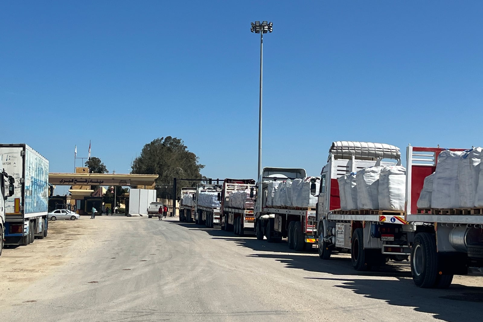 Trucks line up at the Egyptian side of the Rafah border crossing between Egypt and the Gaza Strip on Sunday, March 2, 2025. (AP Photo/Mohamed Arafat)