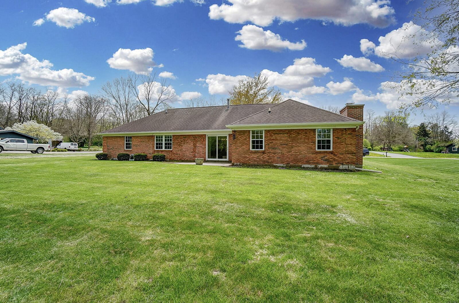 In back, the home has two sliding glass doors and a concrete patio as well as an open yard and trees and a stream at the rear of the lot. CONTRIBUTED PHOTO