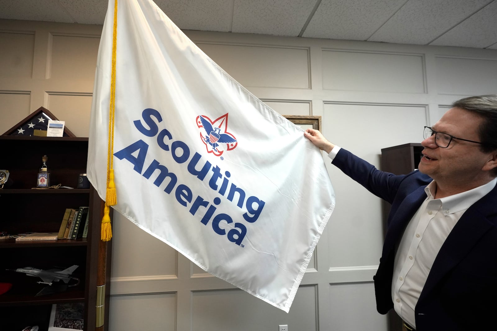 Michael Ramsey displays the Scouting America flag at the organization's headquarters in Irving, Texas, Wednesday, Feb. 5, 2025. (AP Photo/LM Otero)