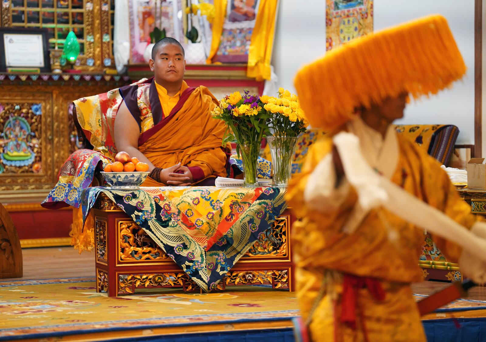 U.S.-born Buddhist lama, Jalue Dorje, watches a traditional Tibetan performance at his 18th birthday and enthronement ceremony in Isanti, Minn., on Saturday, Nov. 9, 2024. (AP Photo/Jessie Wardarski)