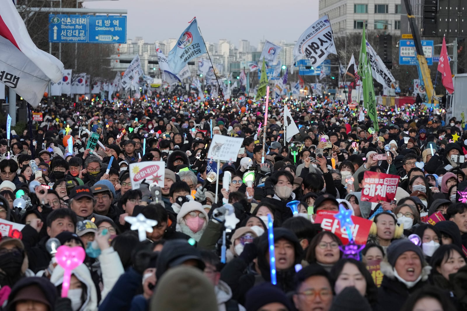 Participants celebrate after hearing the news that South Korea's parliament voted to impeach President Yoon Suk Yeol outside the National Assembly in Seoul, South Korea, Saturday, Dec. 14, 2024. (AP Photo/Lee Jin-man)