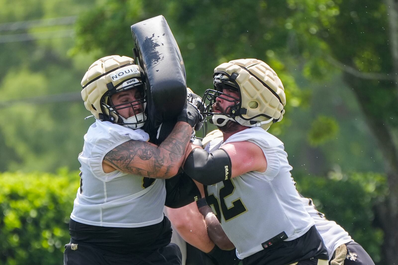 New Orleans Saints offensive lineman Patrick Lucas, right, and guard Nouri Nouili run through drills during an NFL football practice in Metairie, La., Tuesday, May 28, 2024. (AP Photo/Gerald Herbert)