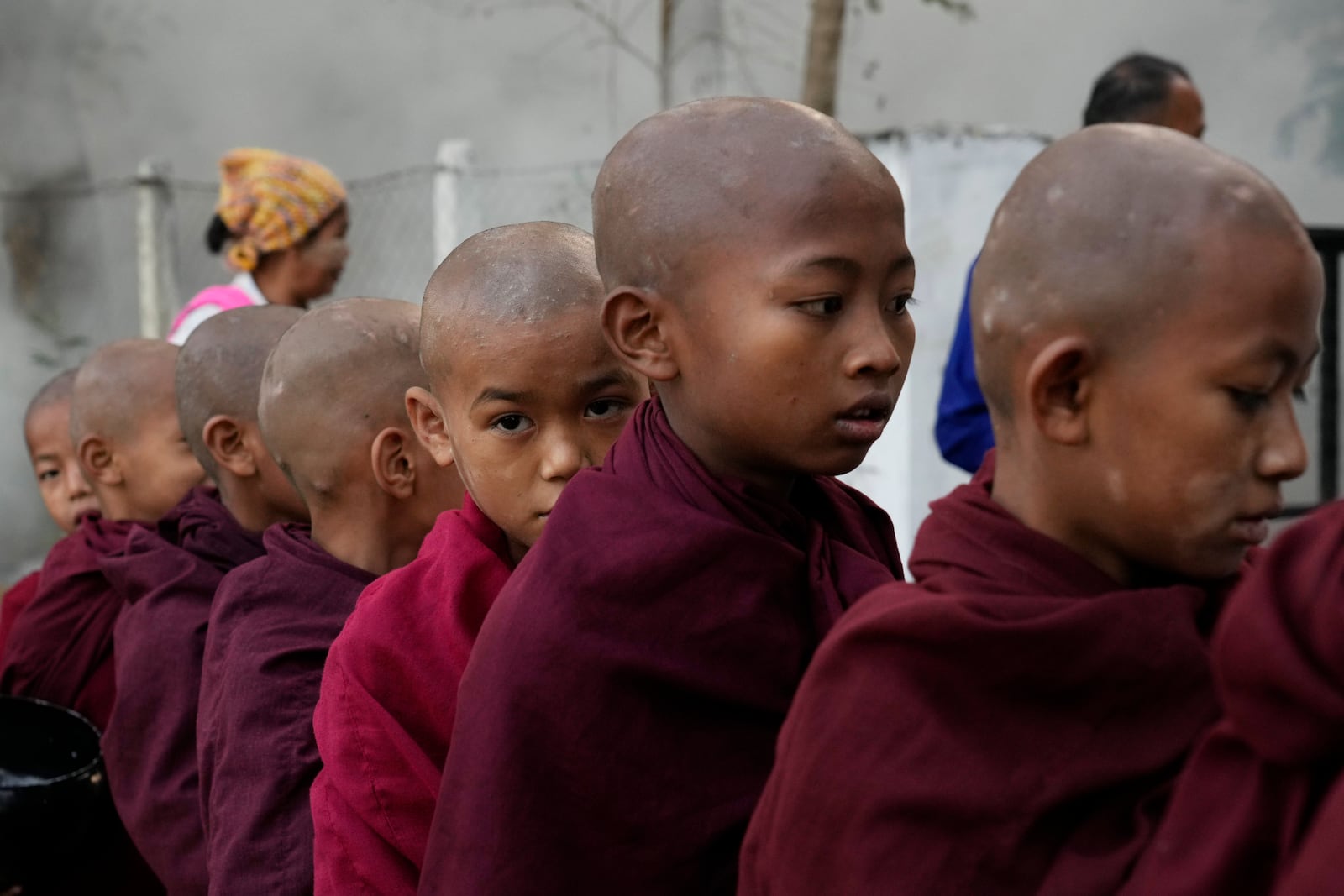 Buddhist novice monks line up to collect their morning alms from Buddhist devotees Saturday, Feb. 1, 2025, in Naypyitaw, Myanmar. (AP Photo/Aung Shine Oo)