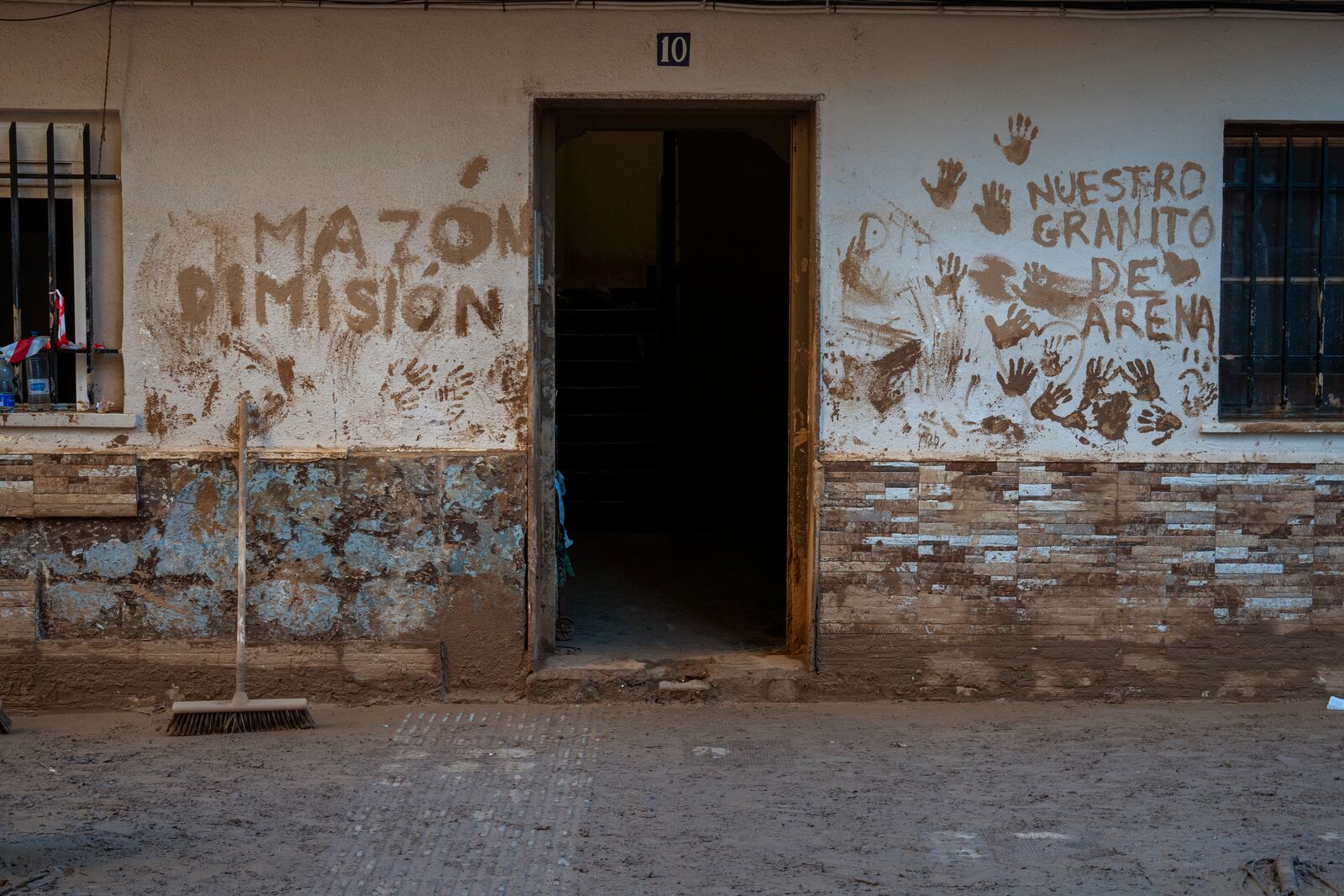 A house affected by flooding is photographed in Massanassa, Valencia, Spain, Friday, Nov. 8, 2024. The graffiti in Spanish means 'Mazon dimisión' in reference to the president of the Valencia community Carlos Mazon. (AP Photo/Emilio Morenatti)