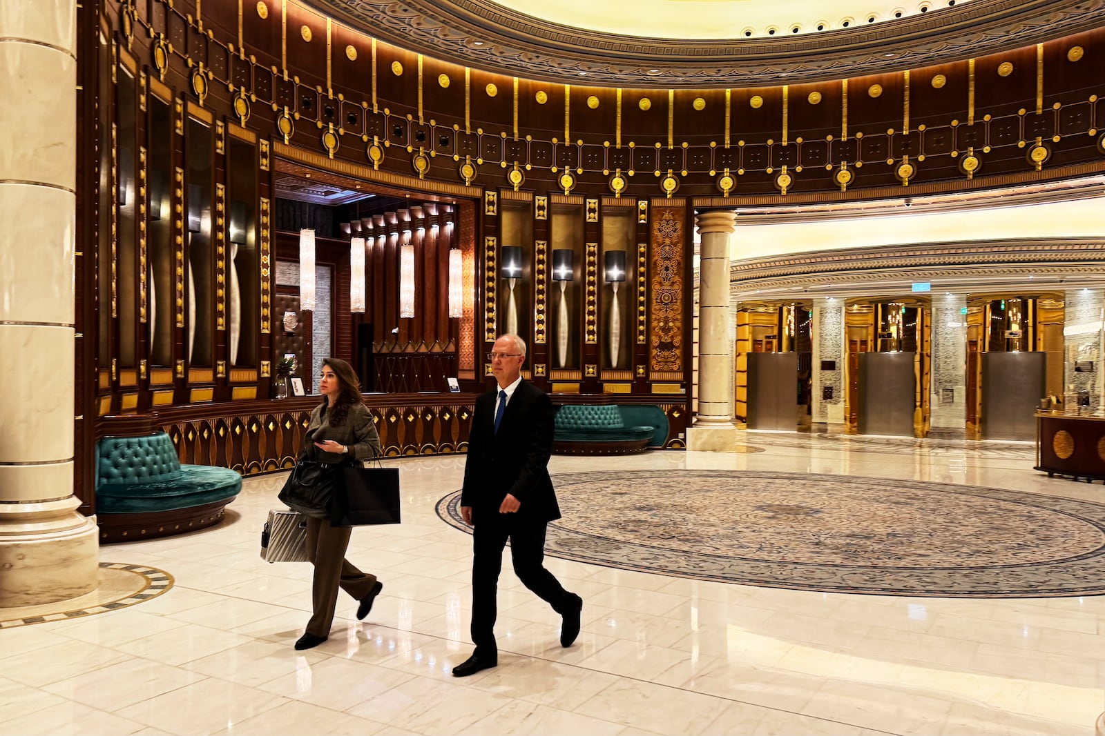 Kirill Dmitriev, the head of the Russian Direct Investment Fund, right, and Maria Medvedeva, the deputy CEO for external communication for the fund, walk across the Ritz Carlton hotel in Riyadh, Saudi Arabia, Tuesday, Feb. 18, 2025. (AP Photo/Baraa Anwer)