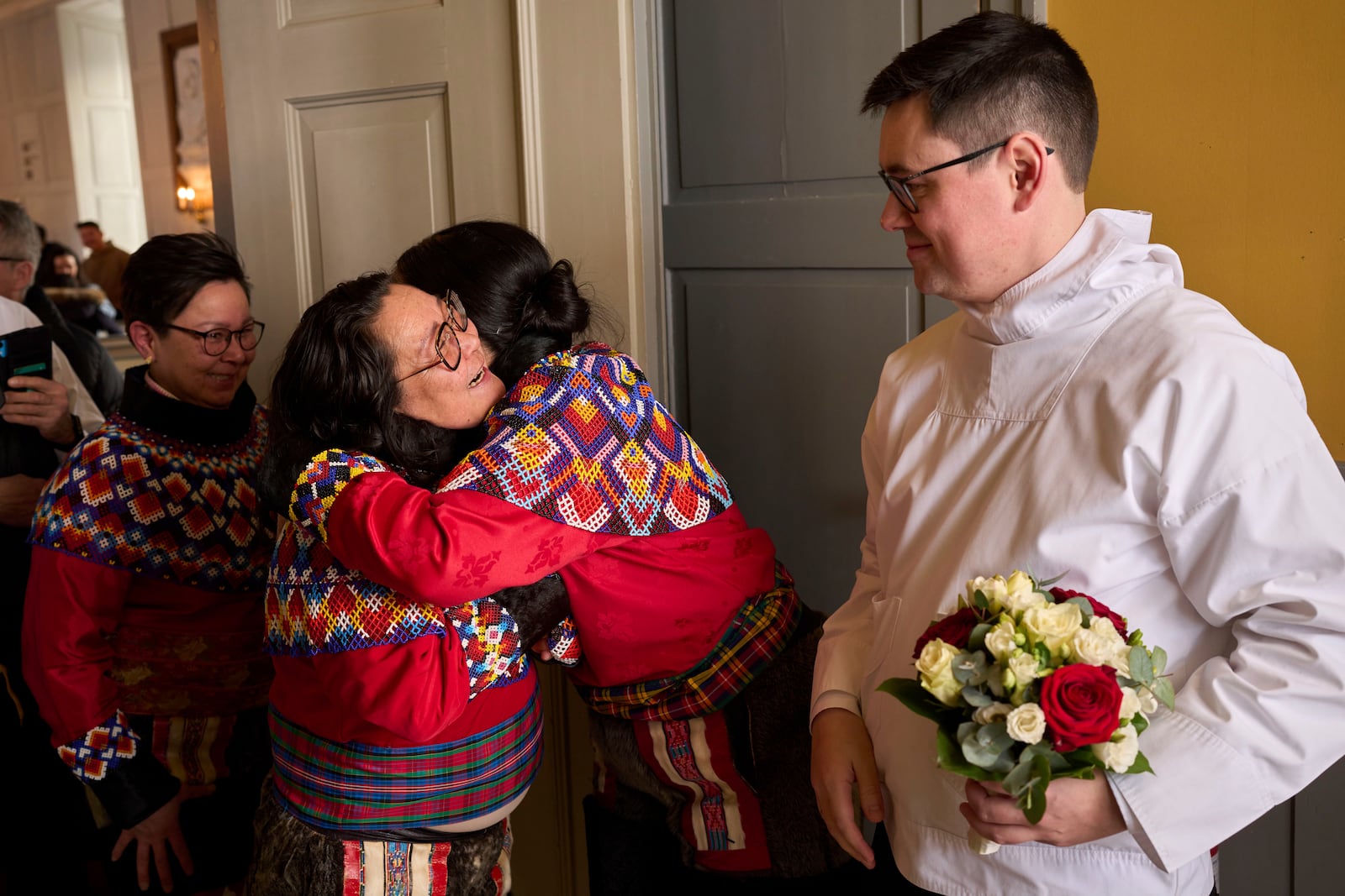 Salik Schmidt and Malu Schmidt welcome relatives and friends during their weeding at the Church of our Savior in Nuuk, Greenland, Saturday, Feb. 15, 2025. (AP Photo/Emilio Morenatti)