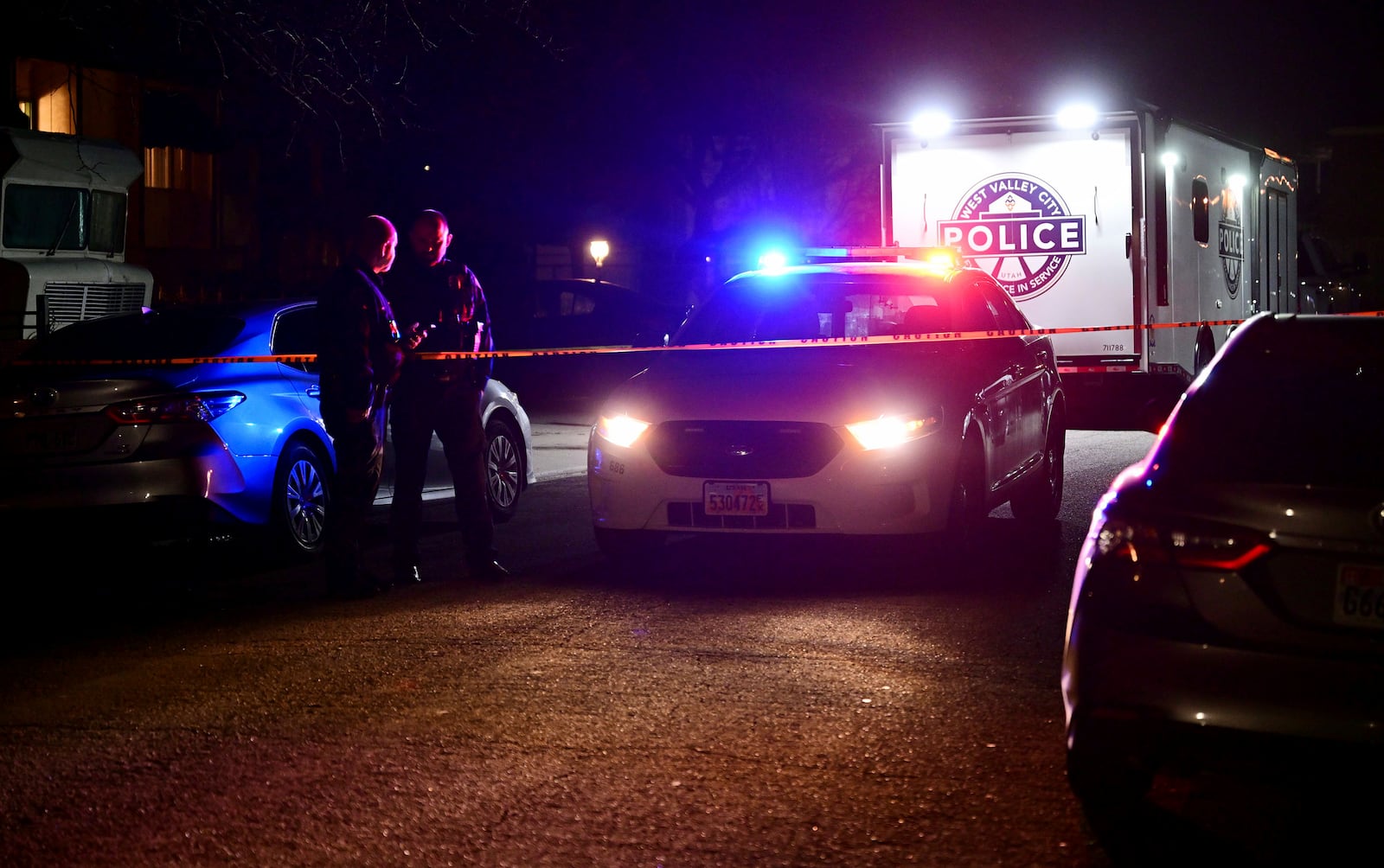 Police investigate a crime scene where they say multiple family members were found dead inside a home in West Valley City, Utah, Tuesday Dec. 17, 2024. (Scott G. Winterton/The Deseret News via AP)