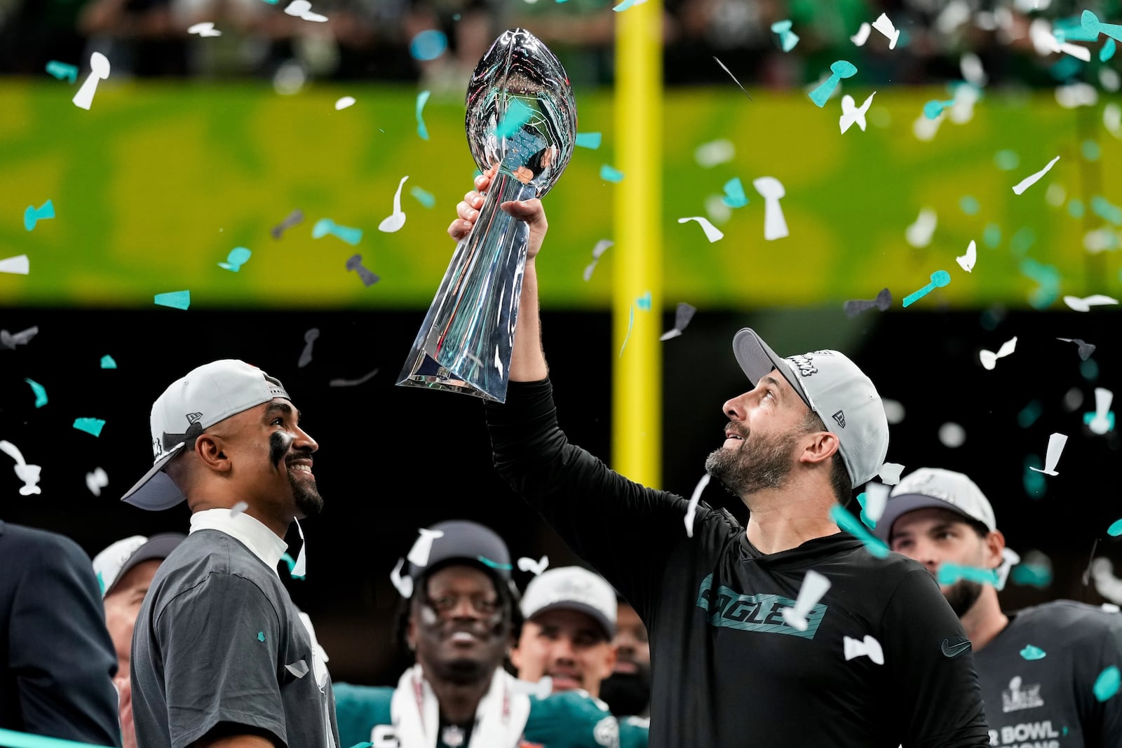 Philadelphia Eagles head coach Nick Sirianni, right, lifts the Vince Lombardi Trophy next to quarterback Jalen Hurts after defeating the Kansas City Chiefs in the NFL Super Bowl 59 football game, Sunday, Feb. 9, 2025, in New Orleans. (AP Photo/Matt Slocum)