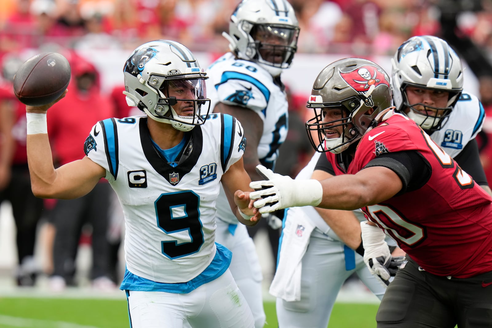 Carolina Panthers quarterback Bryce Young passes under pressure from Tampa Bay Buccaneers defensive end Logan Hall during the first half of an NFL football game Sunday, Dec. 29, 2024, in Tampa, Fla. (AP Photo/Chris O'Meara)