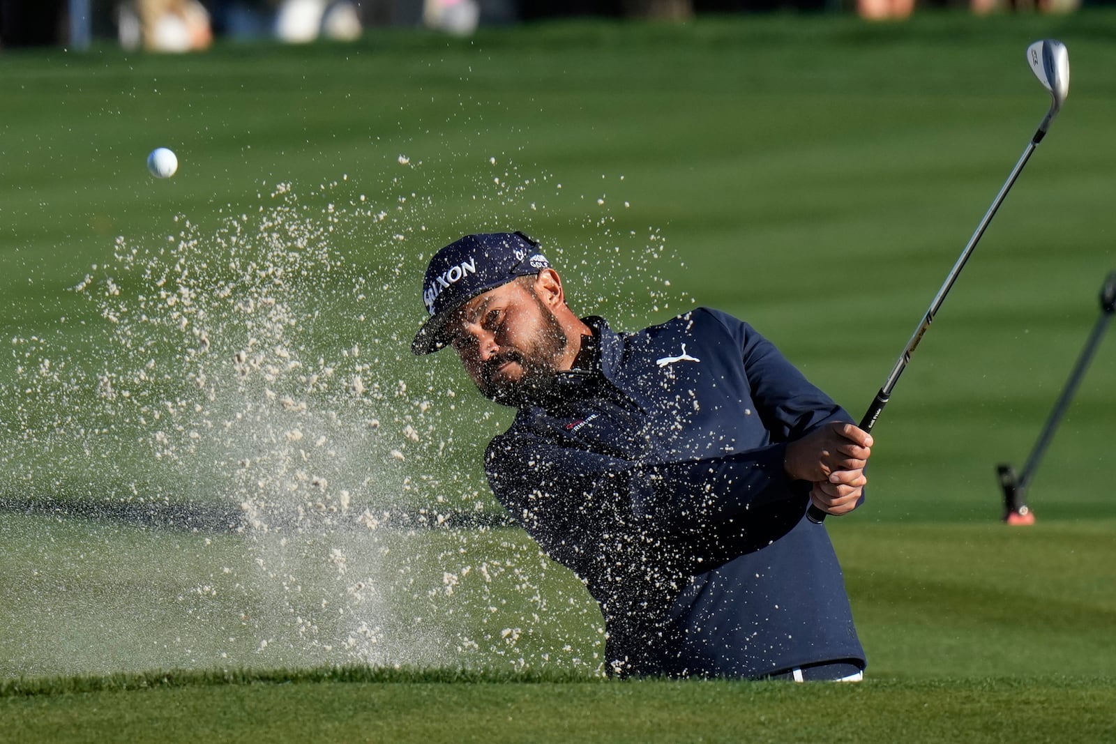 J.J. Spain hits from the sand on the 16th hole during a playoff round of The Players Championship golf tournament Monday, March 17, 2025, in Ponte Vedra Beach, Fla. (AP Photo/Chris O'Meara)