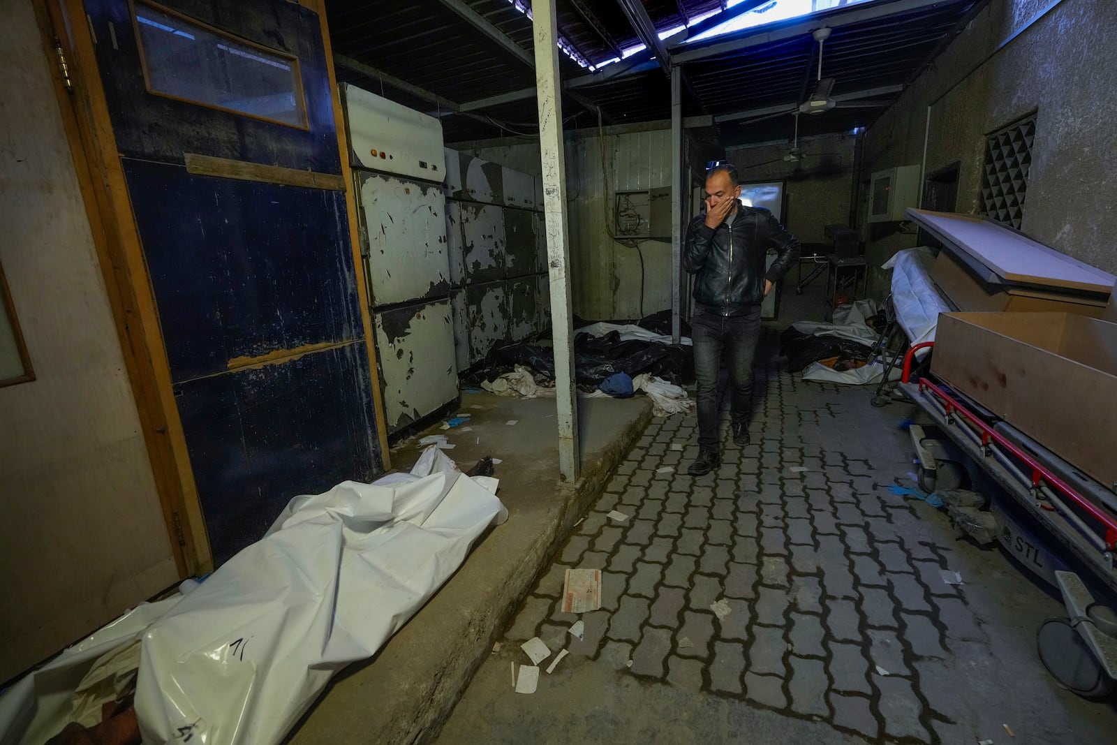 A man leaves the Al-Mojtahed hospital morgue in Damascus, Syria, on Wednesday, Dec. 11, 2024. Many are flocking to morgues, hoping to identify loved ones who have been killed or were imprisoned under the rule of President Bashar Assad, whose government collapsed over the weekend. (AP Photo/Hussein Malla)