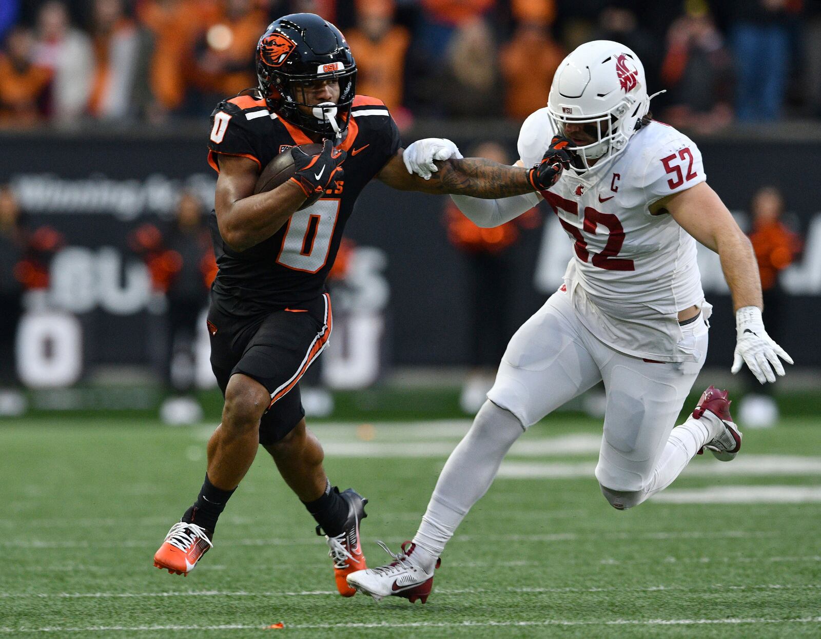 Oregon State running back Anthony Hankerson (0) stiff arms Washington State linebacker Kyle Thornton (52) during the first half of an NCAA college football game Saturday, Nov. 23, 2024, in Corvallis, Ore. (AP Photo/Mark Ylen)