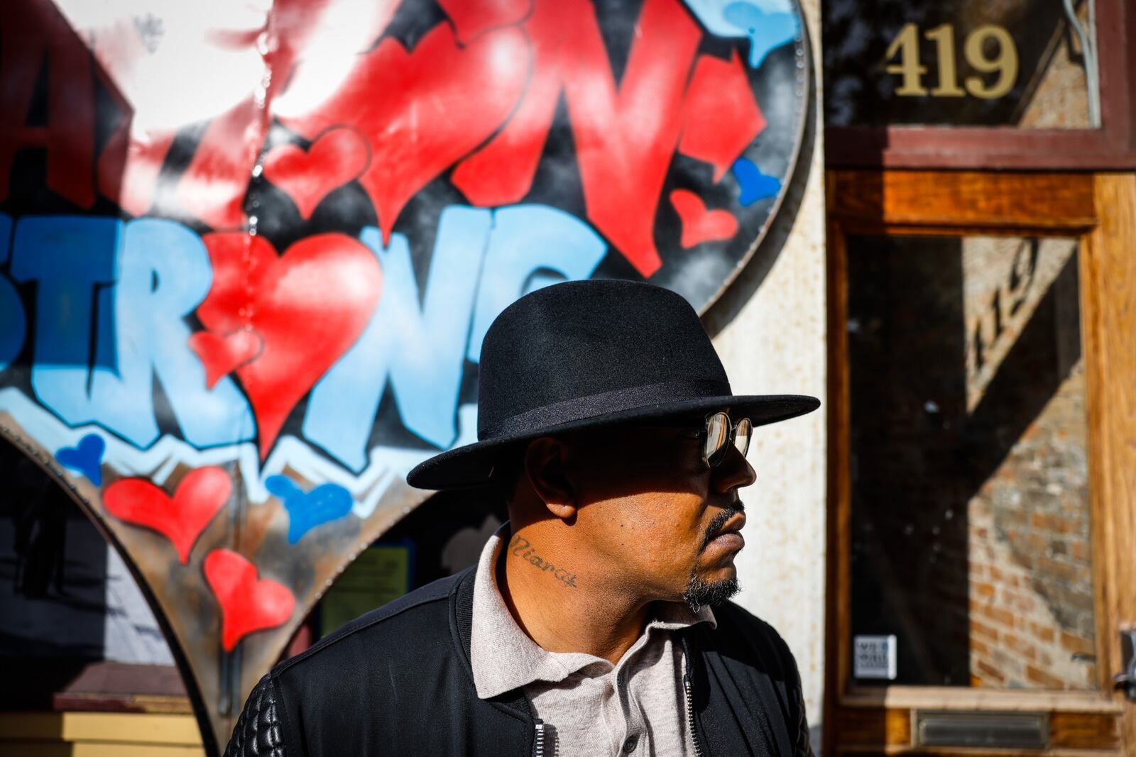 Dion Green outside of Ned Peppers Bar where his father, Derrick Fudge of Springfield, died in his arms following a mass shooting Aug. 4, 2019, in Dayton's historic Oregon District. JIM NOELKER/STAFF