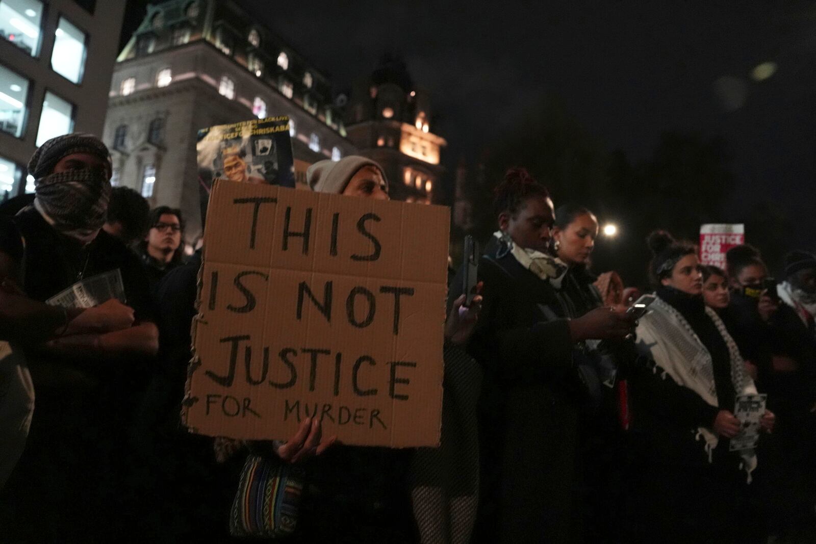 People demonstrate outside the Old Bailey in central London, Monday Oct. 21, 2024, after the London police officer who fatally shot Chris Kaba was acquitted of murder. (Jordan Pettitt/PA via AP)