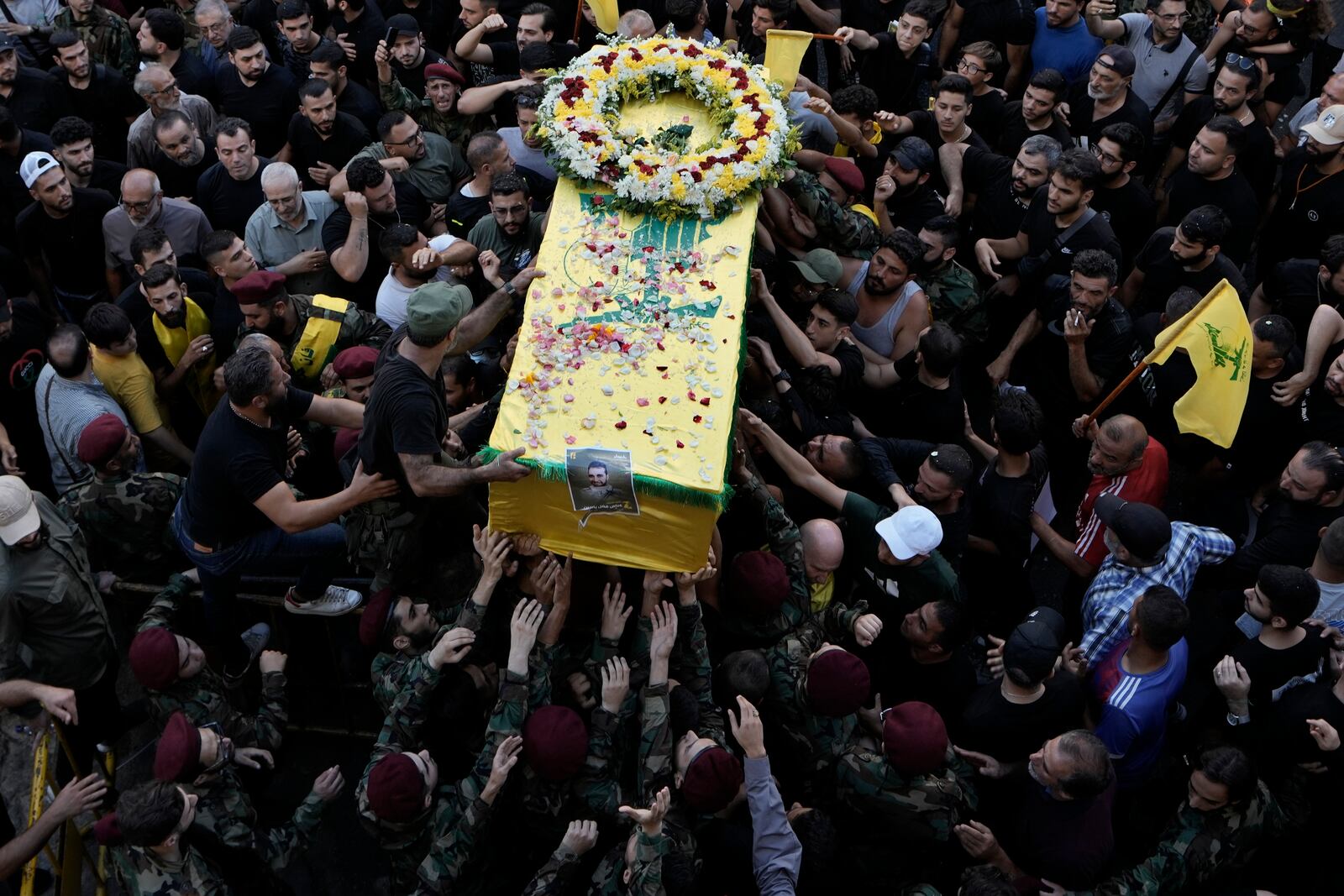 FILE - Hezbollah fighters carry a coffin during a funeral procession in the southern suburb of Beirut, Lebanon, Sept. 18, 2024. (AP Photo/Bilal Hussein, File)