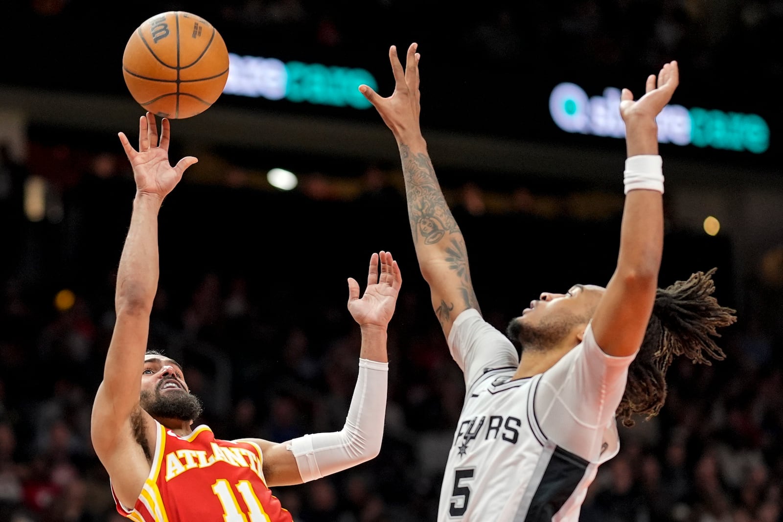 Atlanta Hawks guard Trae Young (11) shoots against San Antonio Spurs guard Stephon Castle (5) during the second half of an NBA basketball game, Wednesday, Feb. 5, 2025, in Atlanta. (AP Photo/Mike Stewart)