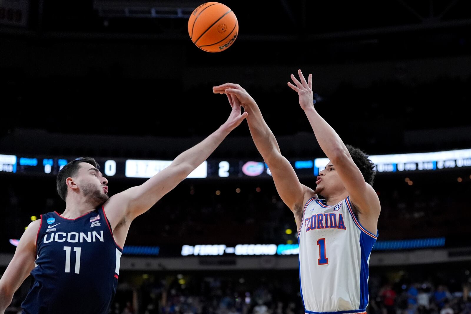 Florida guard Walter Clayton Jr. (1) shoots for three in front of Connecticut forward Alex Karaban (11) during the first half in the second round of the NCAA college basketball tournament, Sunday, March 23, 2025, in Raleigh, N.C. (AP Photo/Stephanie Scarbrough)