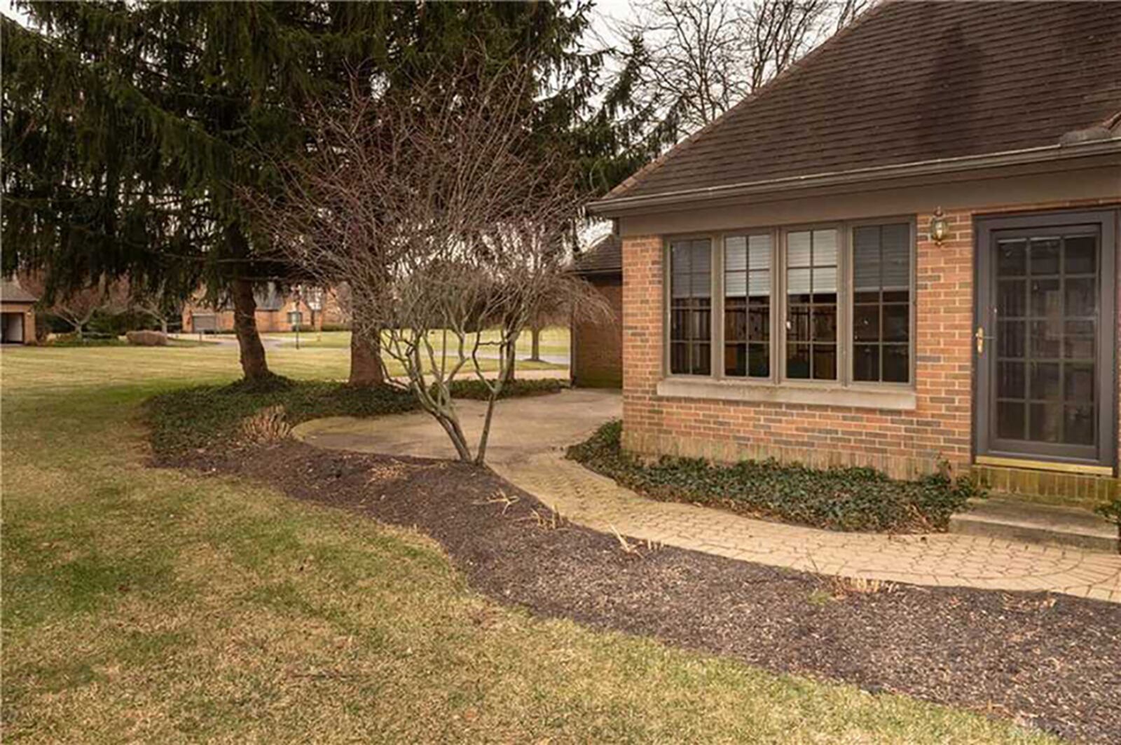 The rear features brick and stone pavers that connect to garage, mature trees and heavy landscaping. CONTRIBUTED PHOTO