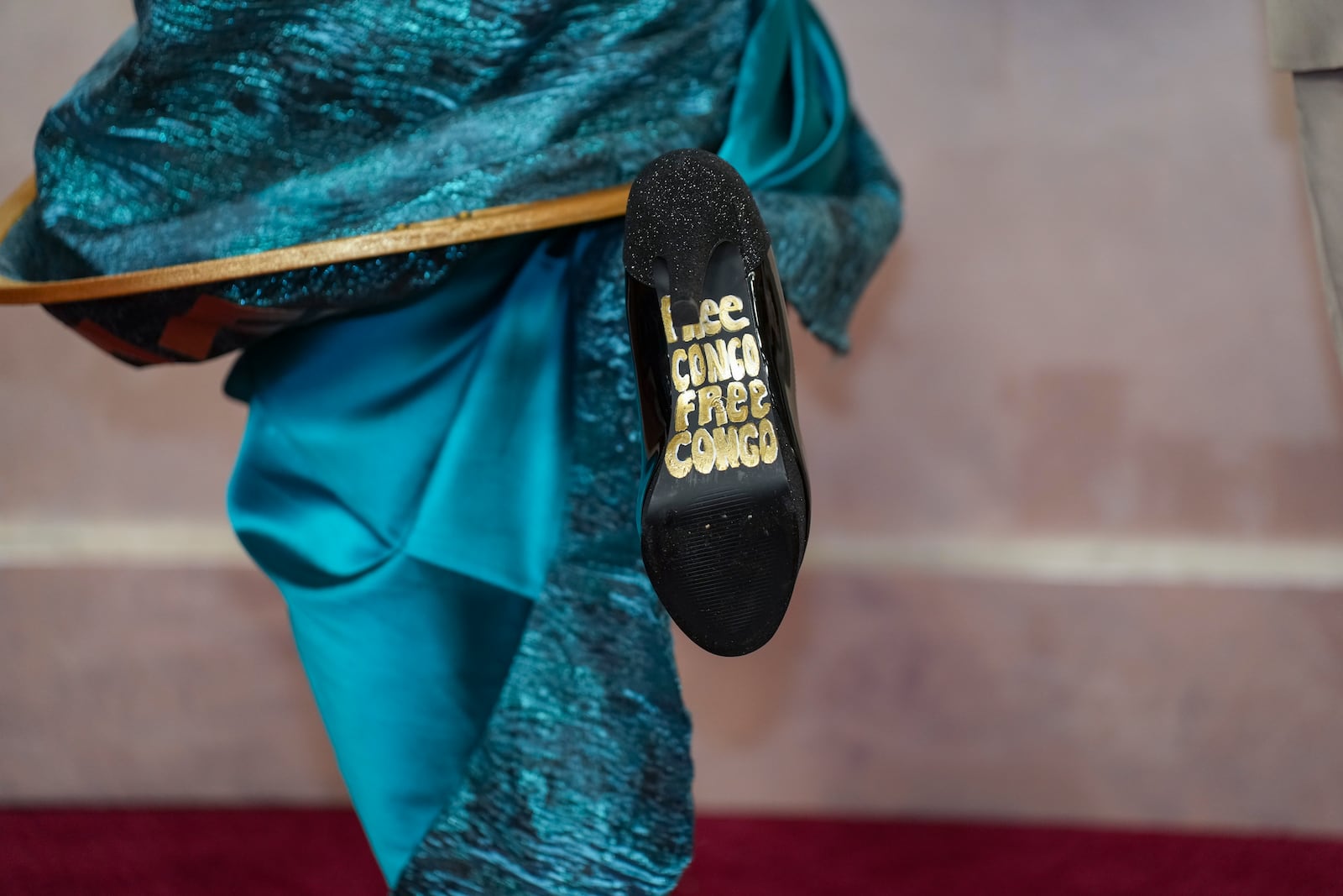 Kayo Shekoni shows the bottom of her shoe as she arrives at the Oscars on Sunday, March 2, 2025, at the Dolby Theatre in Los Angeles. (AP Photo/Jae C. Hong)