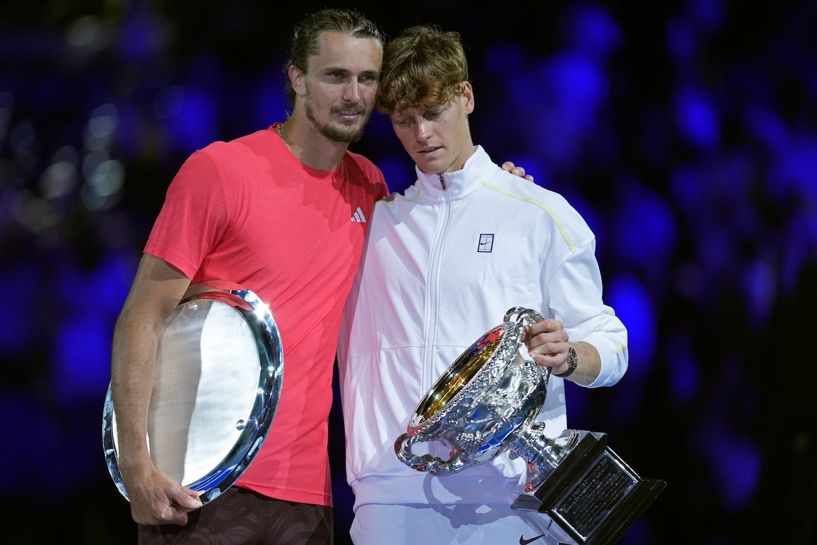 Jannik Sinner, right, of Italy holds the Norman Brookes Challenge Cup after defeating Alexander Zverev of Germany in the men's singles final at the Australian Open tennis championship in Melbourne, Australia, Sunday, Jan. 26, 2025. (AP Photo/Ng Han Guan)