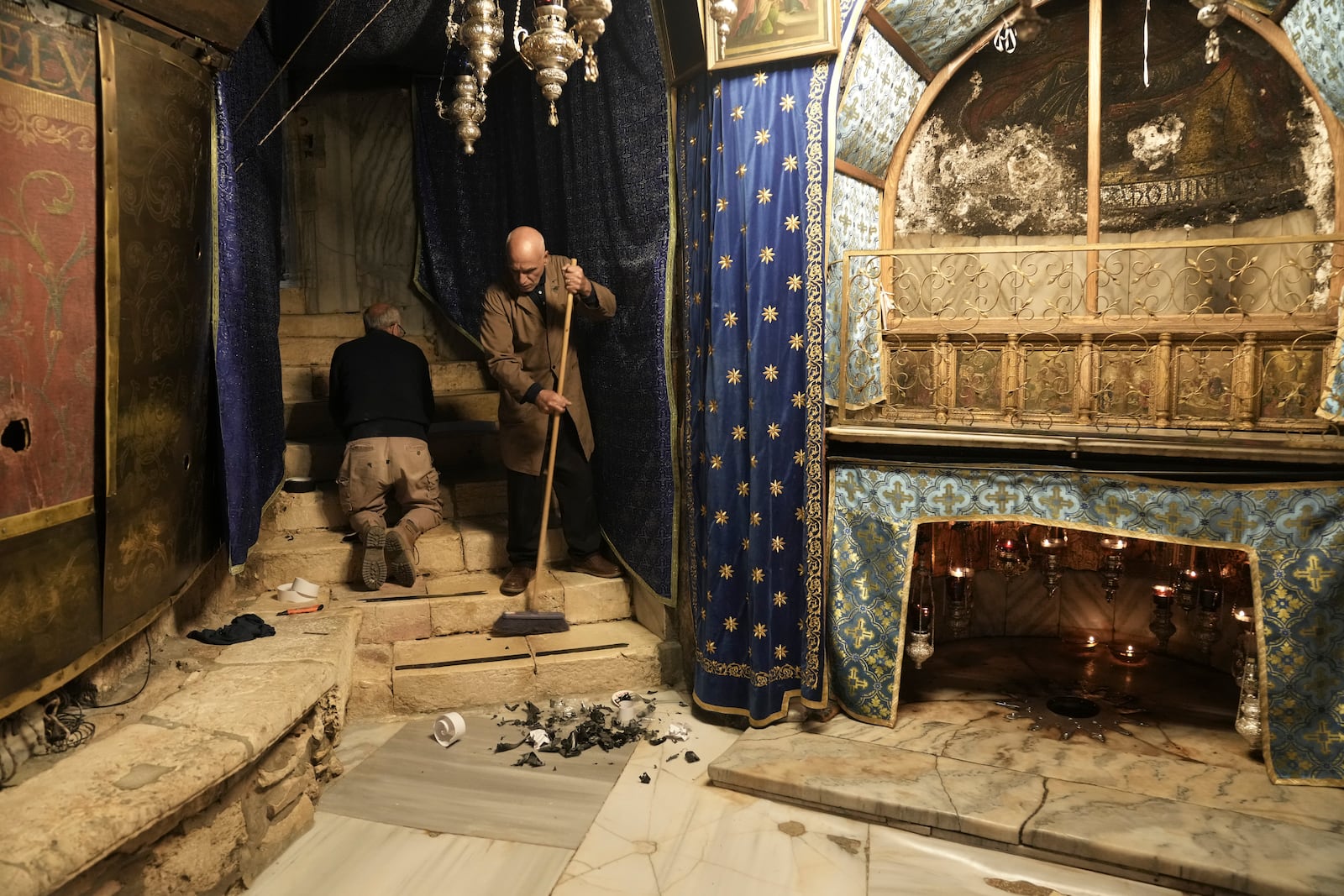 Workers in the Church of the Nativity, where Christians believe Jesus Christ was born, ahead of Christmas in the West Bank city of Bethlehem, Tuesday, Dec. 17, 2024. (AP Photo/Mahmoud Illean)