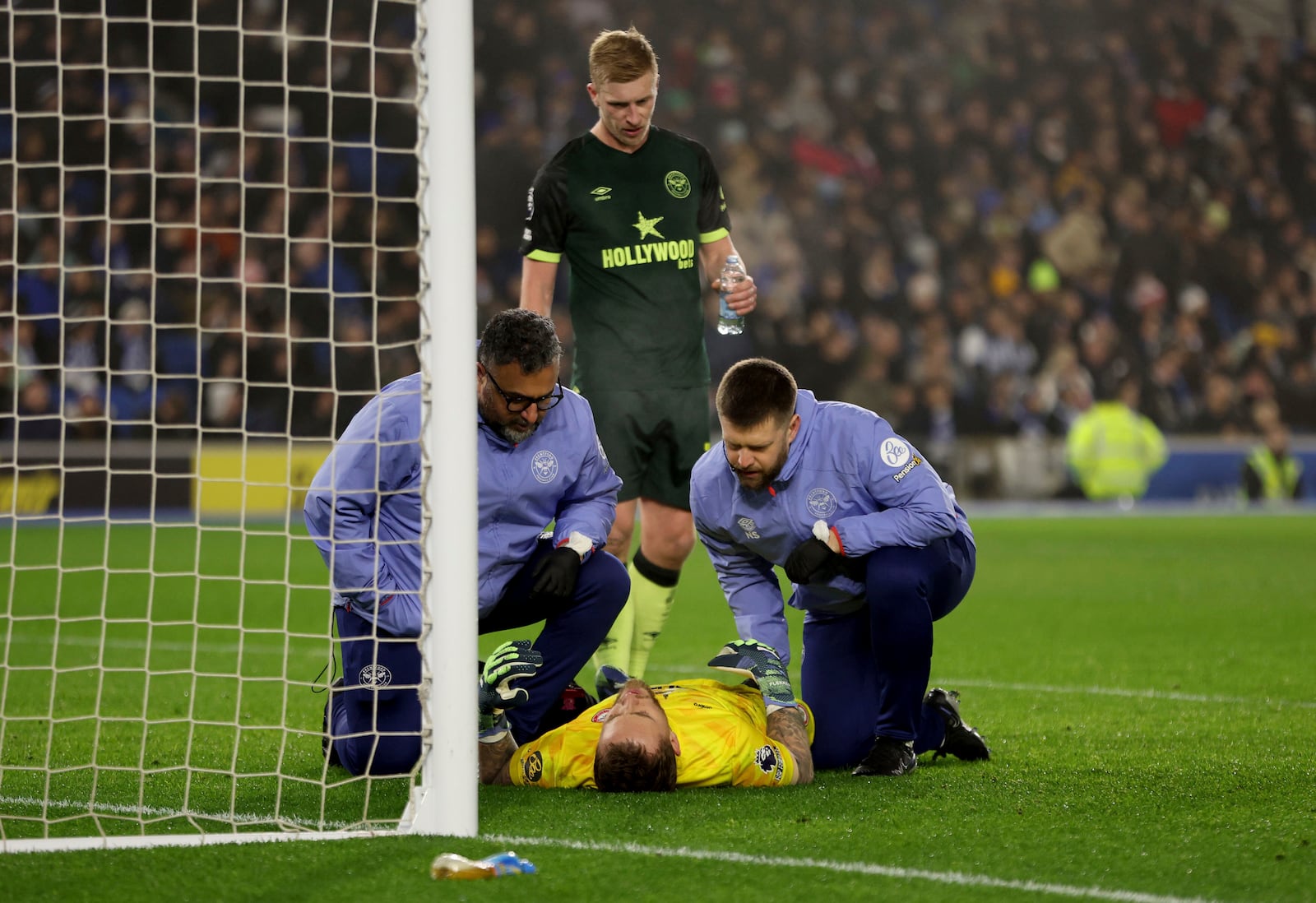 Brentford's goalkeeper Mark Flekken receives treatment for an injury during the English Premier League soccer match between Brighton & Hove Albion and CF Brentford in Brighton and Hove, England, Friday, Dec 27, 2024. (Steven Paston/PA via AP)