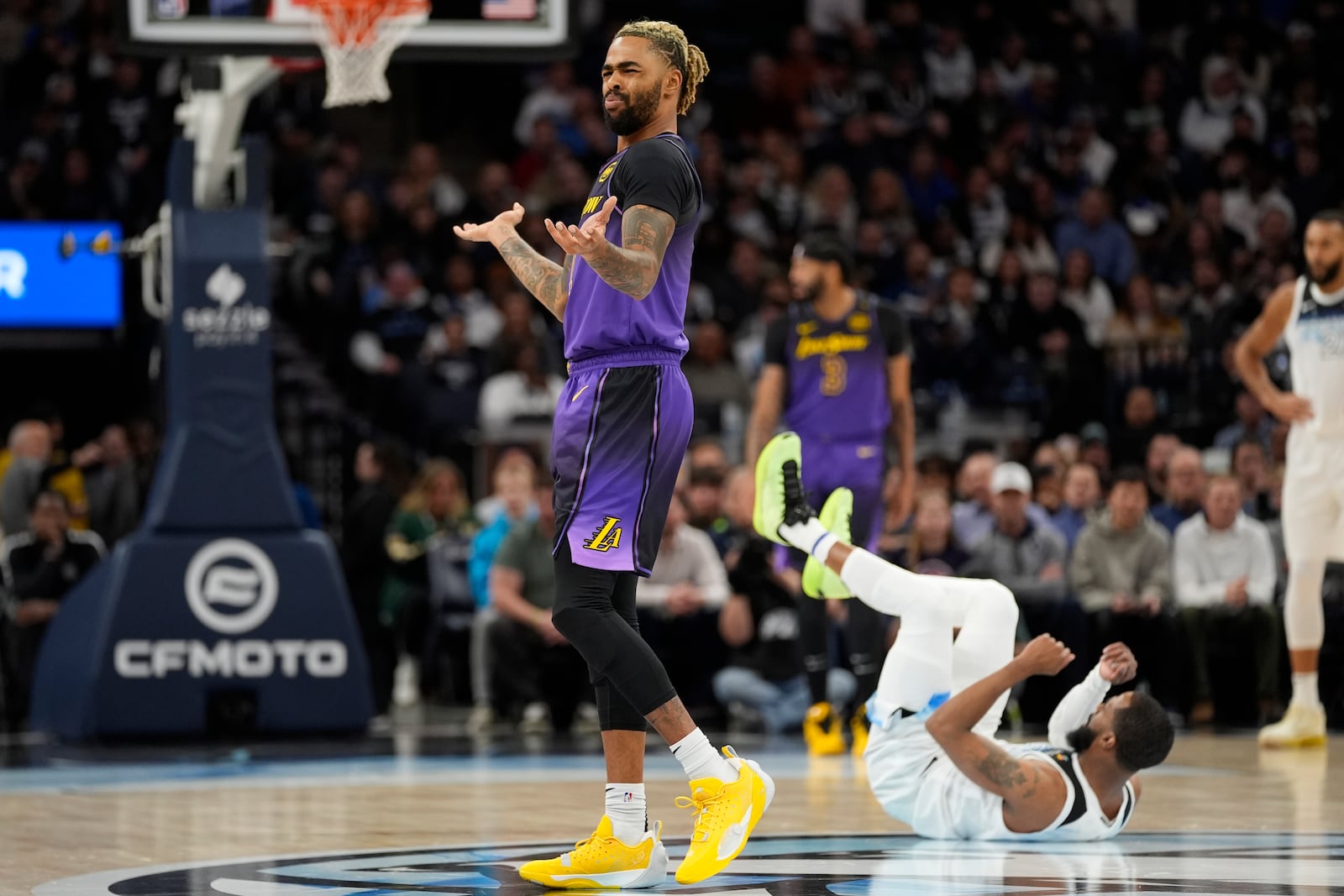 Los Angeles Lakers guard D'Angelo Russell, left, reacts after being called for a foul during the first half of an NBA basketball game against the Minnesota Timberwolves, Monday, Dec. 2, 2024, in Minneapolis. (AP Photo/Abbie Parr)