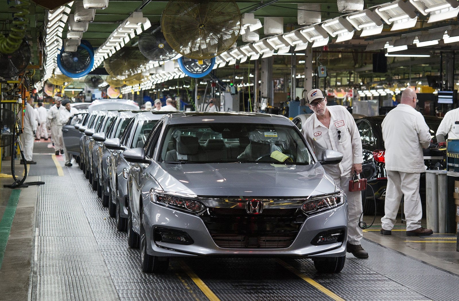 Employees look over 2018 Honda Accord vehicle before being driven off the assembly line at the Honda of America Manufacturing Inc. Marysville Auto Plant in Marysville in December 2017. Bloomberg photo by Ty Wright.