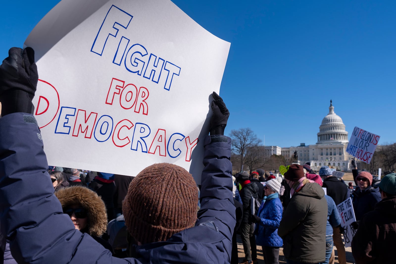 People protest as part of the “No Kings Day” protest on Presidents Day in Washington, in support of federal workers and against recent actions by President Donald Trump and Elon Musk, Monday, Feb. 17, 2025, by the Capitol in Washington. The protest was organized by the 50501 Movement, which stands for 50 Protests 50 States 1 Movement. (AP Photo/Jacquelyn Martin)