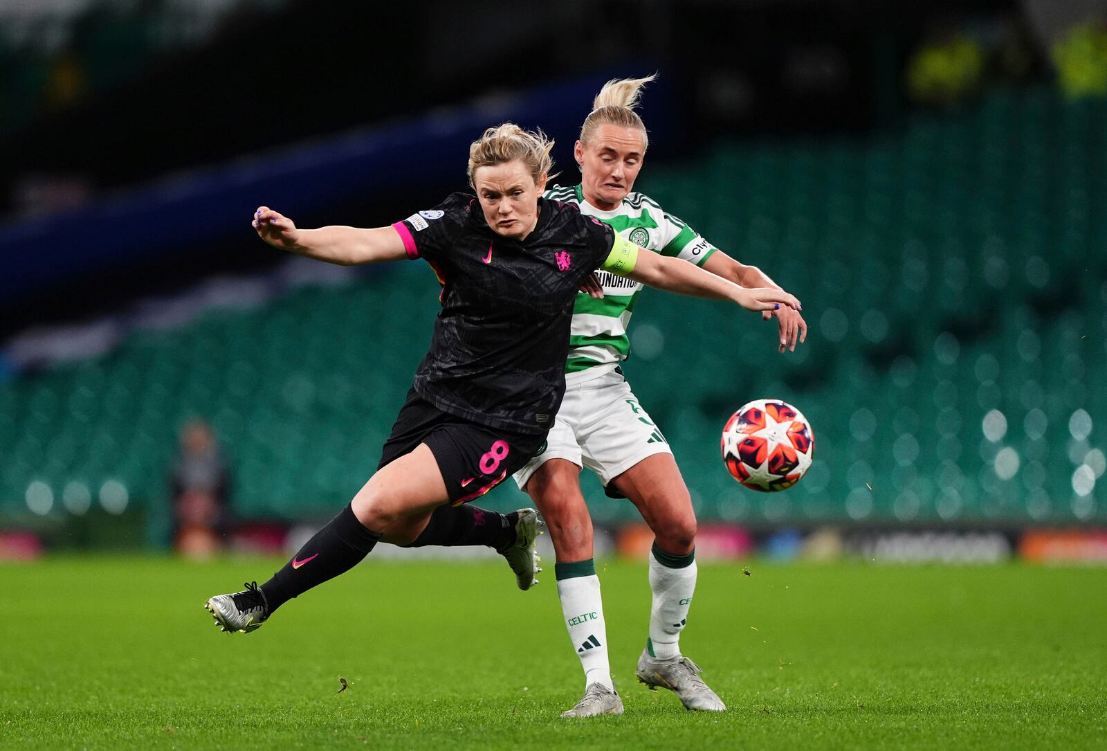 Chelsea's Erin Cuthbert, left and Celtic's Natalie Ross vie for the ball, during the Women's Champions League, group B soccer match between Celtic Women and Chelsea Women, at Celtic Park, Glasgow, Scotland, Wednesday Nov. 13, 2024. (Andrew Milligan/PA via AP)