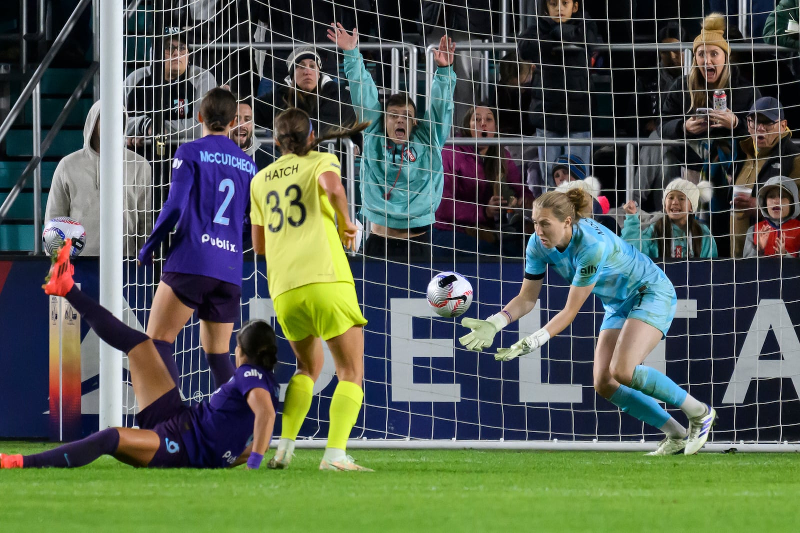 Orlando Pride goalkeeper Anna Moorhouse, right, blocks a shot on goal by Washington Spirit during the second half of the NWSL championship soccer game at CPKC Stadium, Saturday, Nov. 23, 2024, in Kansas City, Mo. (AP Photo/Reed Hoffmann)