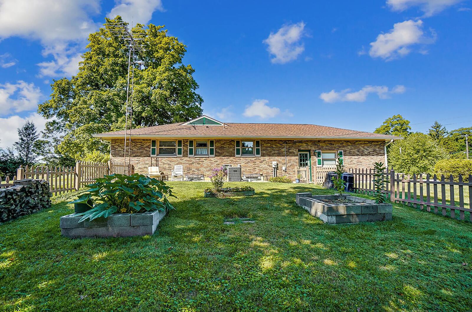 The rear of the home features a concrete patio, partially fenced back yard and a variety of trees, including butternut, elderberry, apple, peach, cherry and black walnut. CONTRIBUTED PHOTO