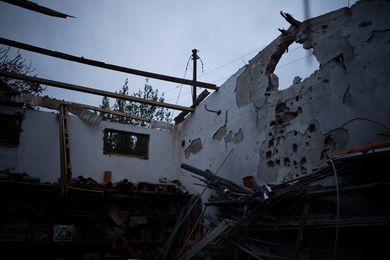 A damaged warehouse that was hit by a rocket fired from Lebanon two days before the start of the ceasefire between Israel and Hezbollah, stands in the Kibbutz Malkiya, northern Israel, Wednesday, Nov. 27, 2024. (AP Photo/Leo Correa)