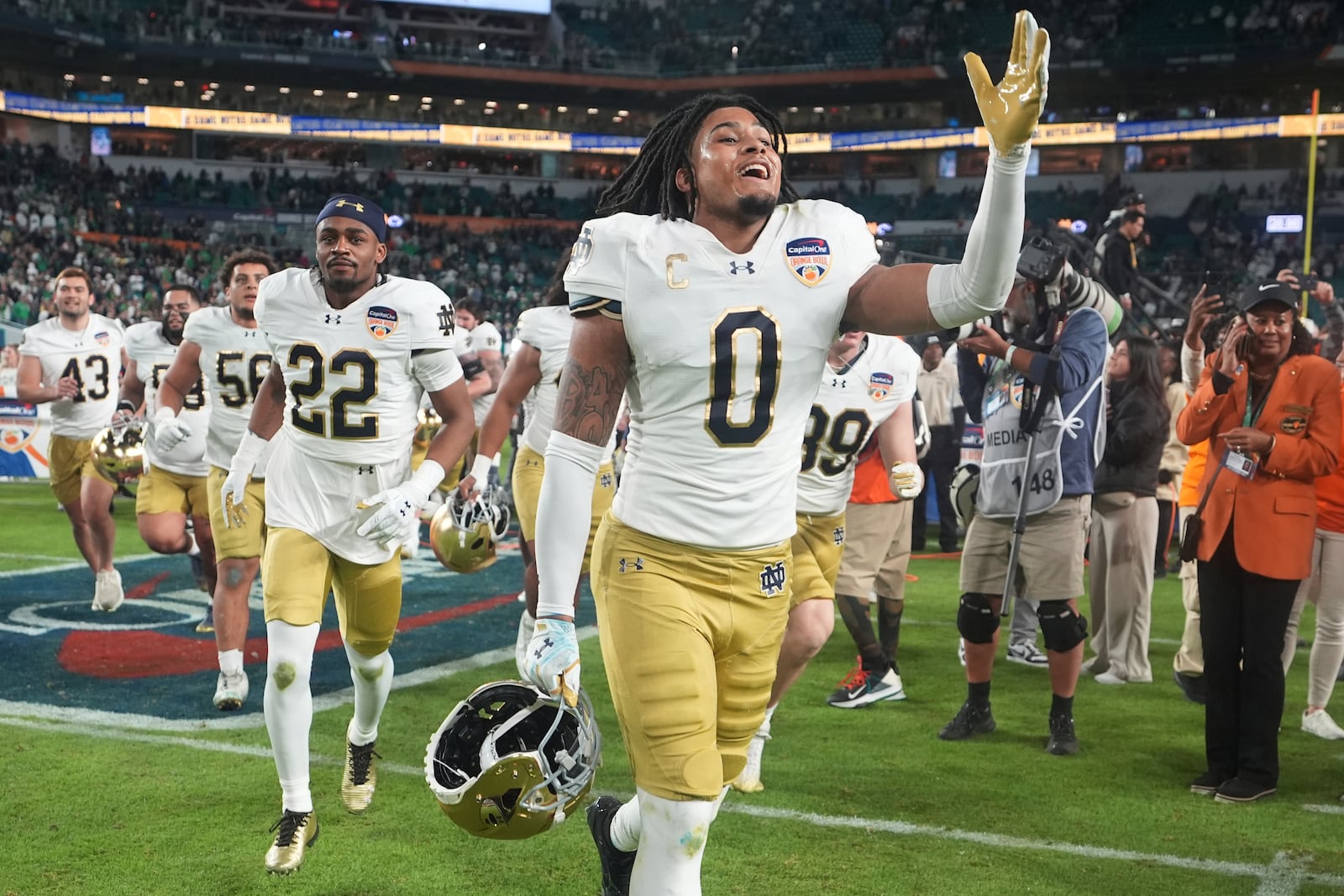 Notre Dame safety Xavier Watts (0) celebrates at the end of the Orange Bowl College Football Playoff semifinal game against Penn State, Thursday, Jan. 9, 2025, in Miami Gardens, Fla. (AP Photo/Lynne Sladky)