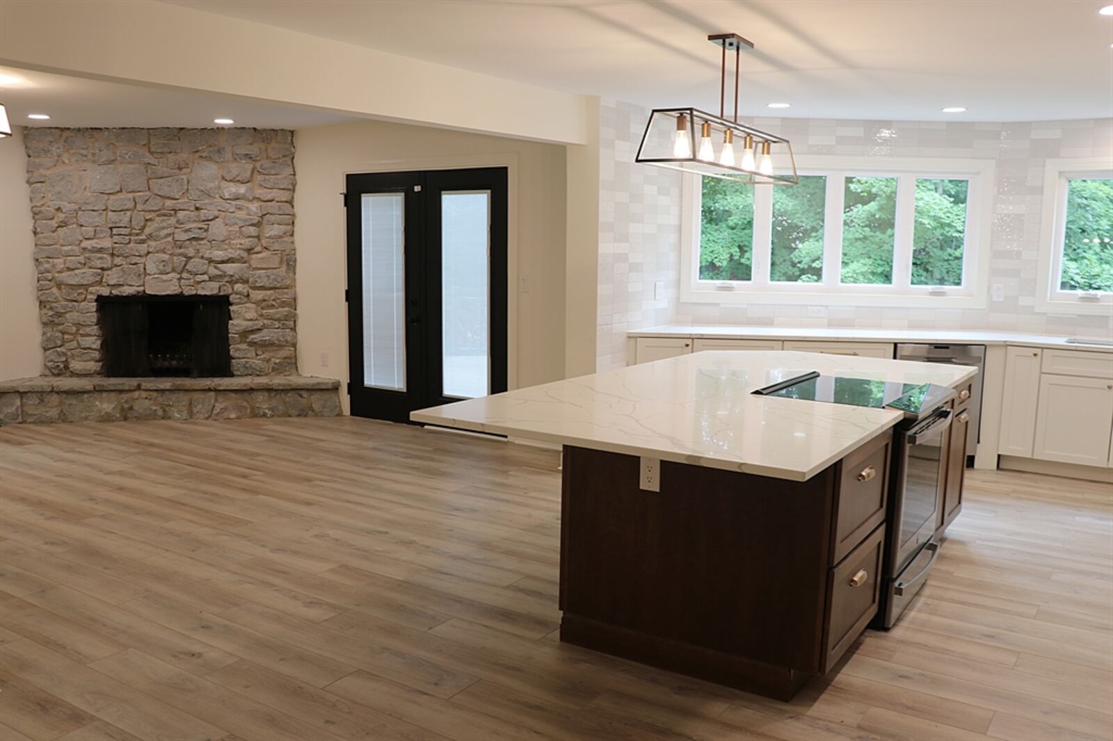 Interior renovations made during the redesign include the kitchen with quartz counters and wood-plank flooring throughout.