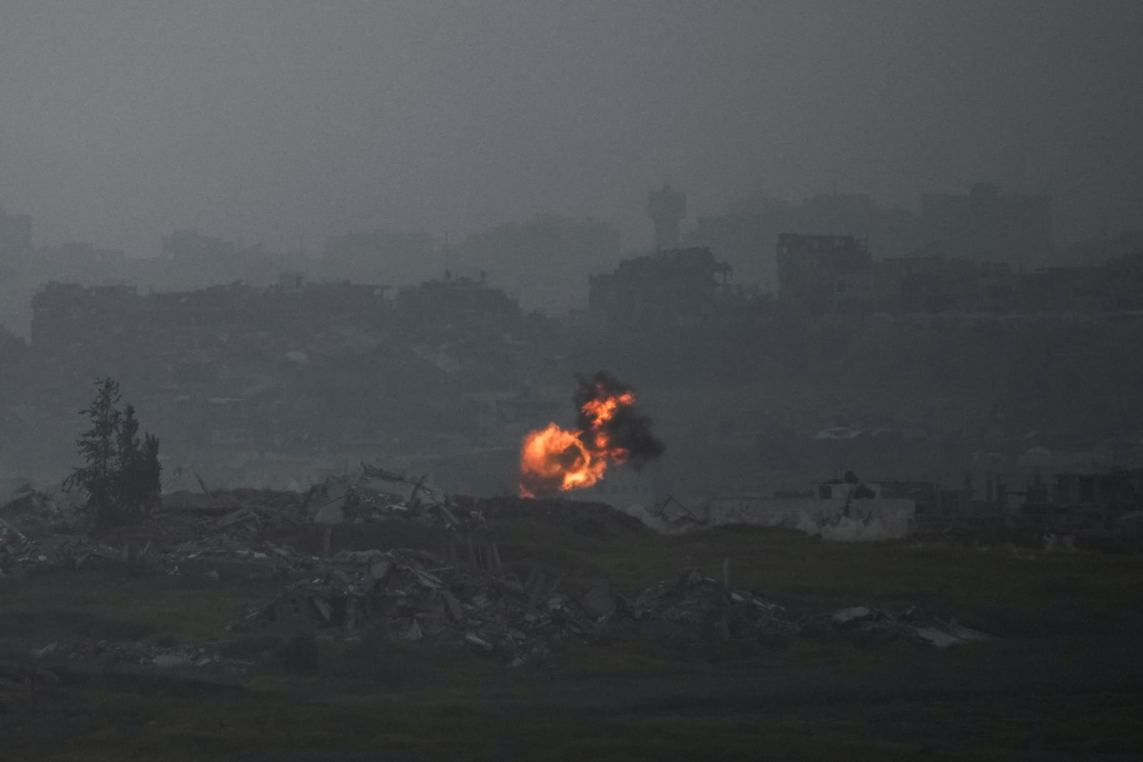 An explosion erupts in the northern Gaza Strip, as seee from southern Israel, on Tuesday, March 18, 2025. (AP Photo/Leo Correa)