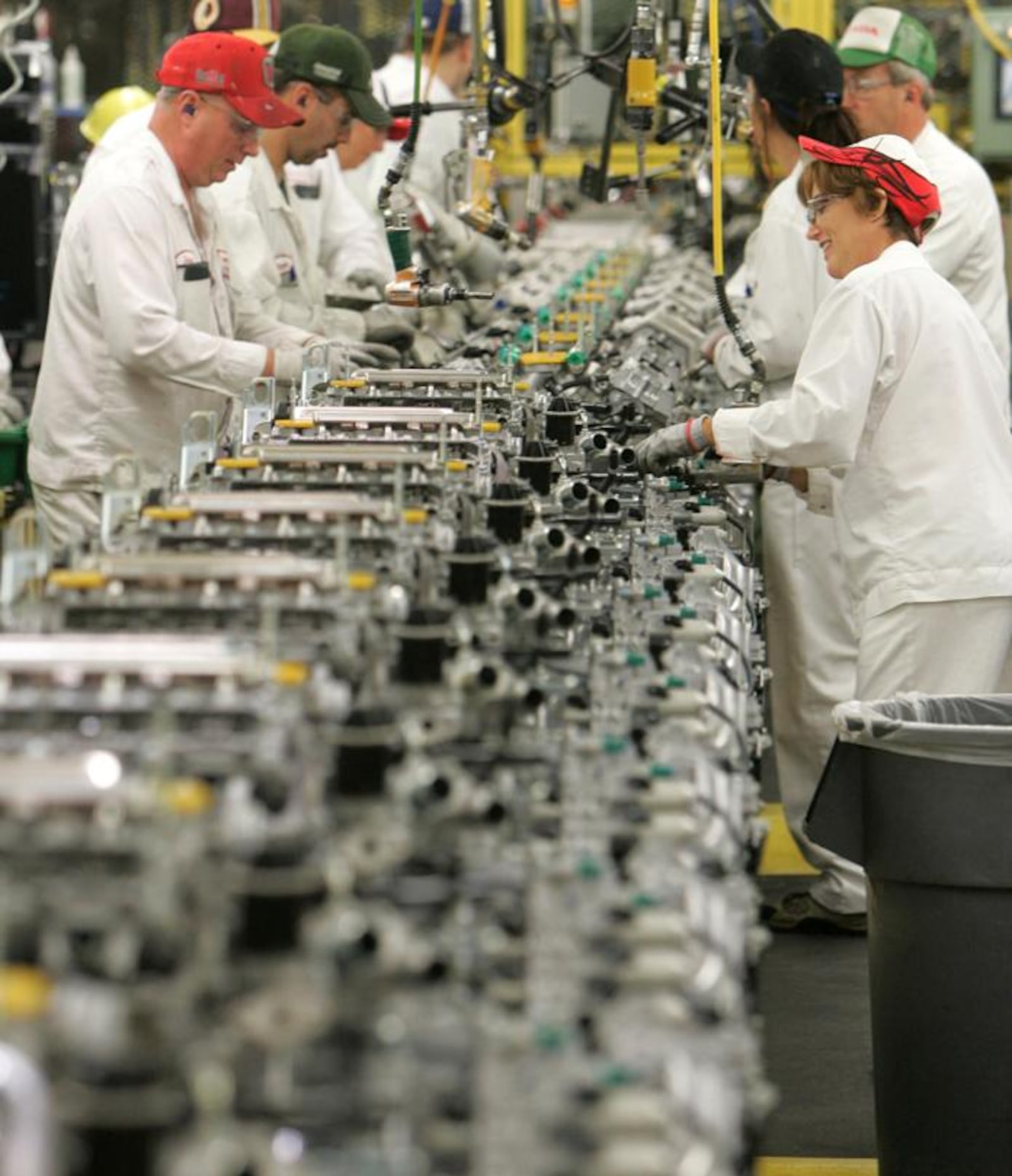 Workers work on a manufacturing line at Honda plant in Anna, Ohio. BILL LACKEY/STAFF