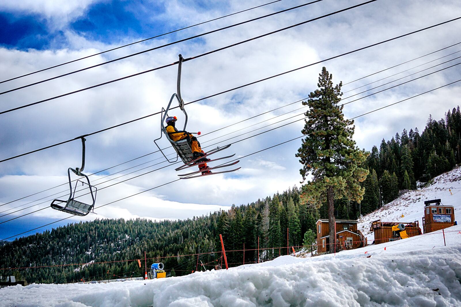 Skiers ride a lift to the slopes after a fresh snowfall at the Palisades Tahoe Ski Resort in Olympic Valley, Calif. for opening day of the ski season on Friday, Nov. 22, 2024. (AP Photo/Brooke Hess-Homeier)