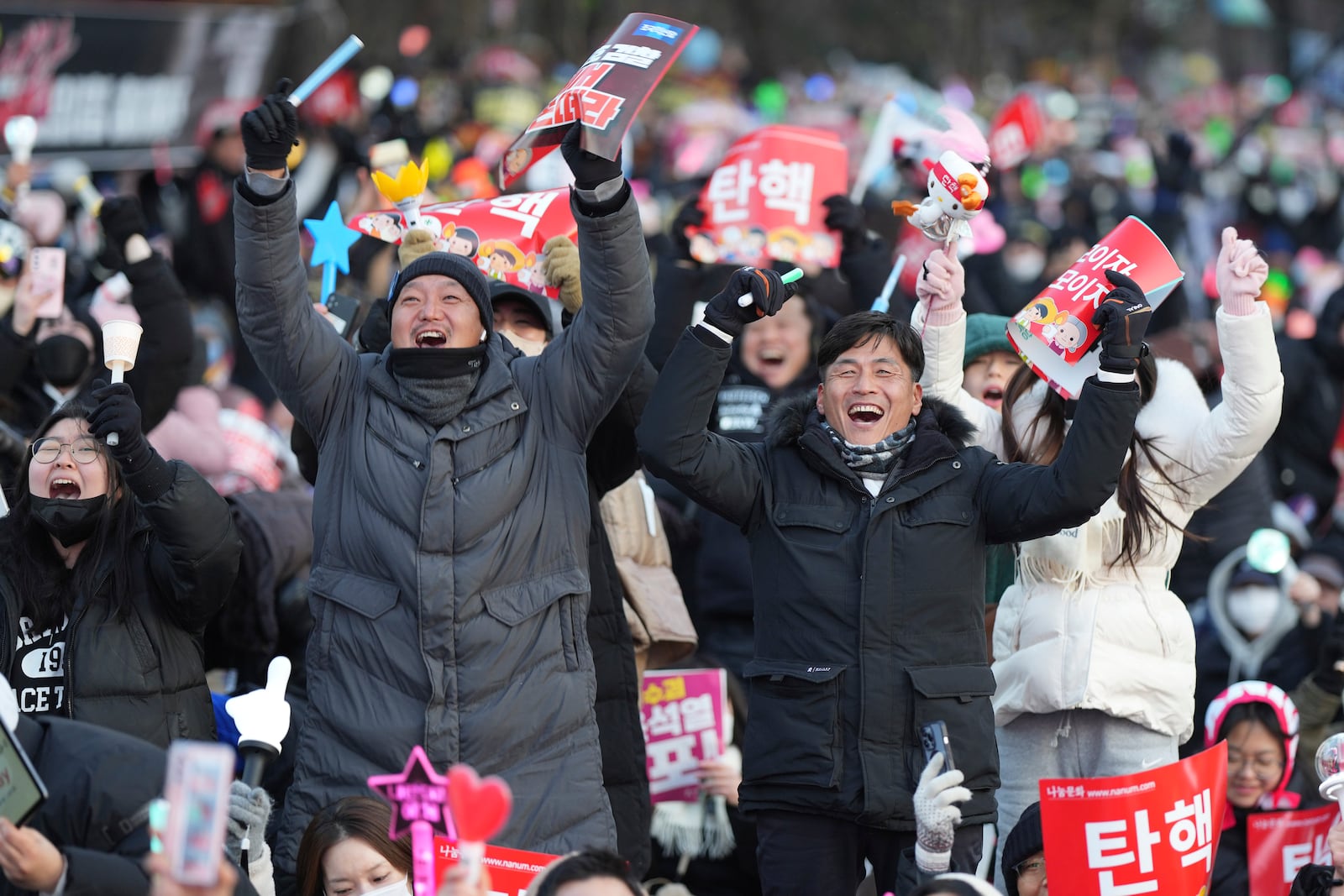 Participants celebrate after hearing the news that South Korea's parliament voted to impeach President Yoon Suk Yeol outside the National Assembly in Seoul, South Korea, Saturday, Dec. 14, 2024. (AP Photo/Lee Jin-man)