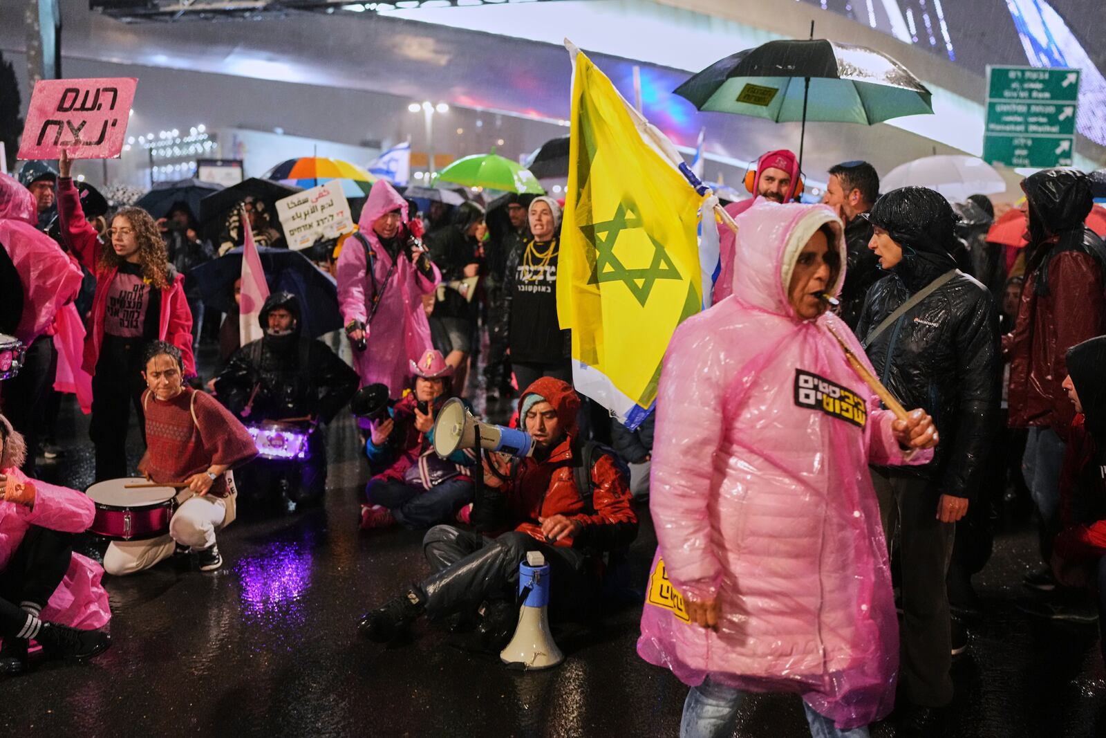 Demonstrators block a road during a protest against Israeli Prime Minister Benjamin Netanyahu's plan to dismiss the head of the Shin Bet internal security service, in Jerusalem on Thursday, March 20, 2025. (AP Photo/Ohad Zwigenberg)