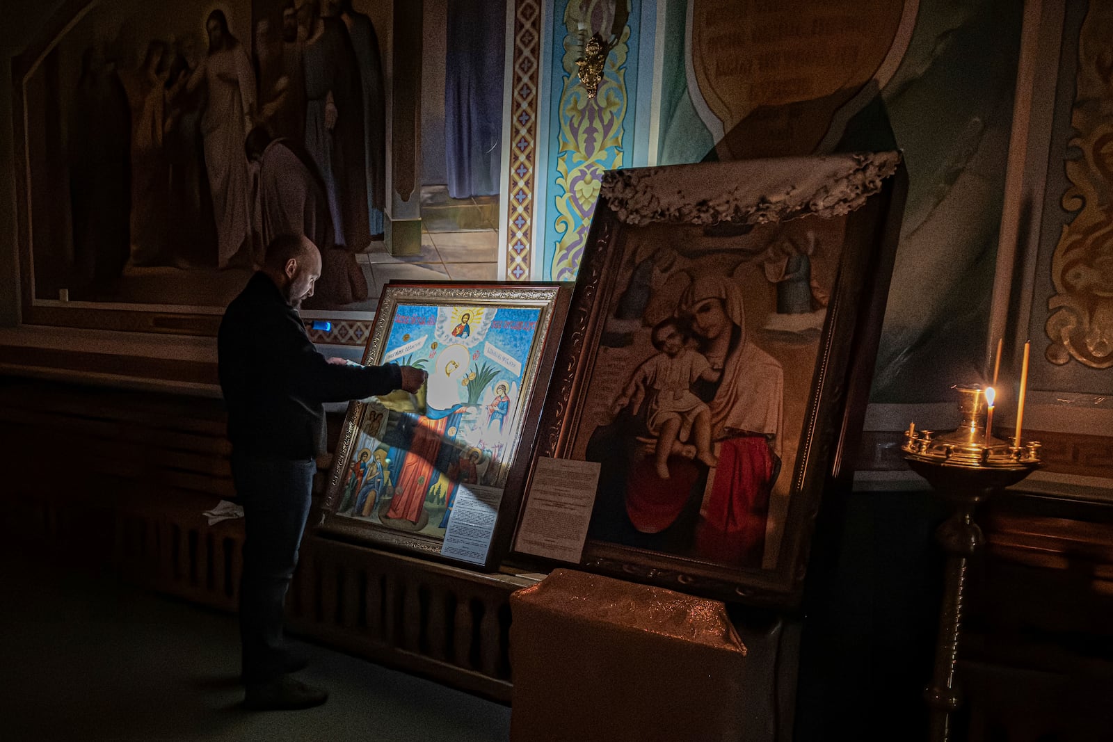 A man prays in front of an icon inside an Orthodox Church in Kurakhove, Donetsk region, Ukraine, on Nov. 7, 2024. (AP Photo/Anton Shtuka)