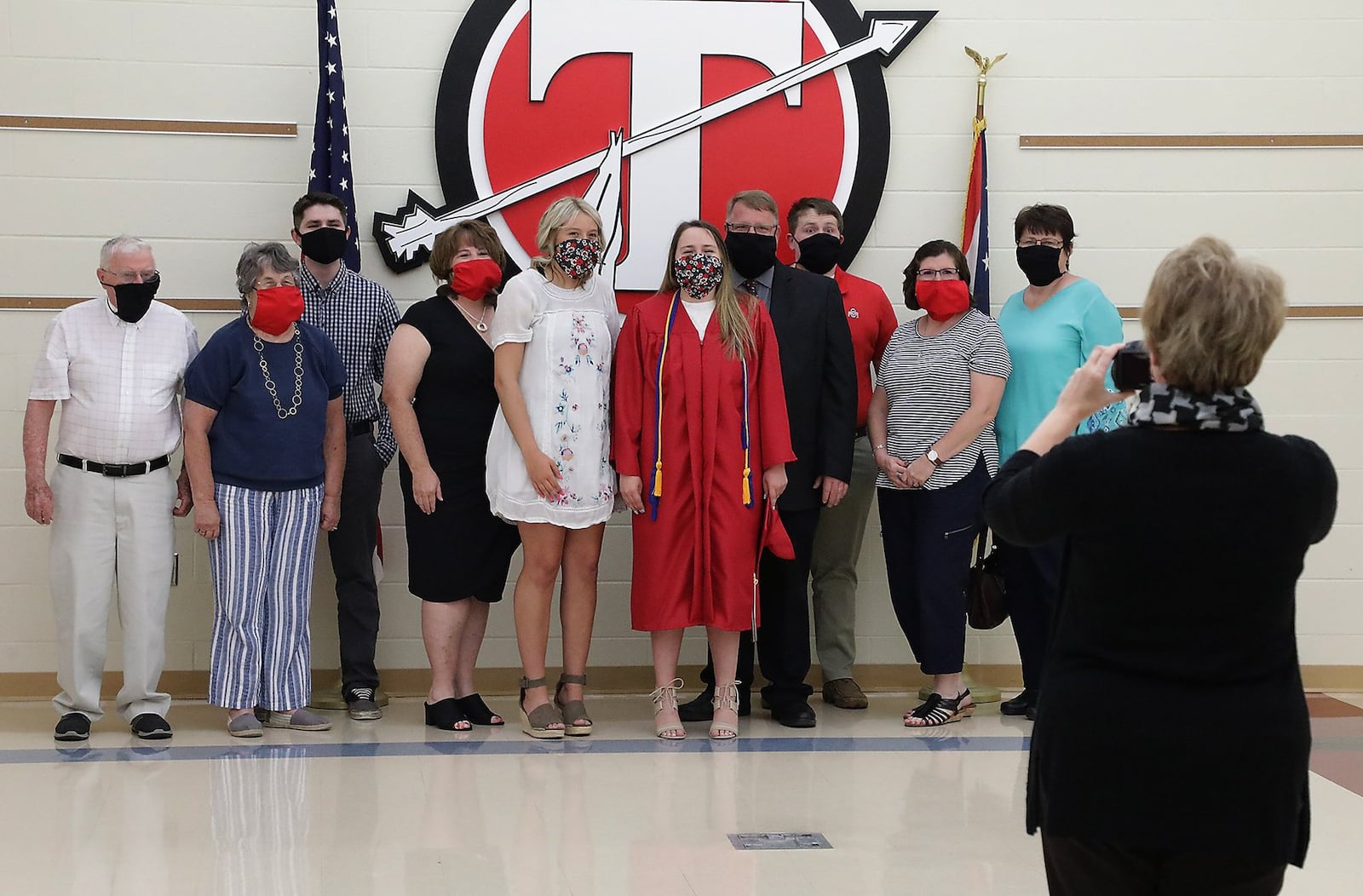 Tecumseh High School graduate Ellie Gehret, center, and her family pose for a picture with masks on during her individual graduation ceremony Monday. BILL LACKEY/STAFF