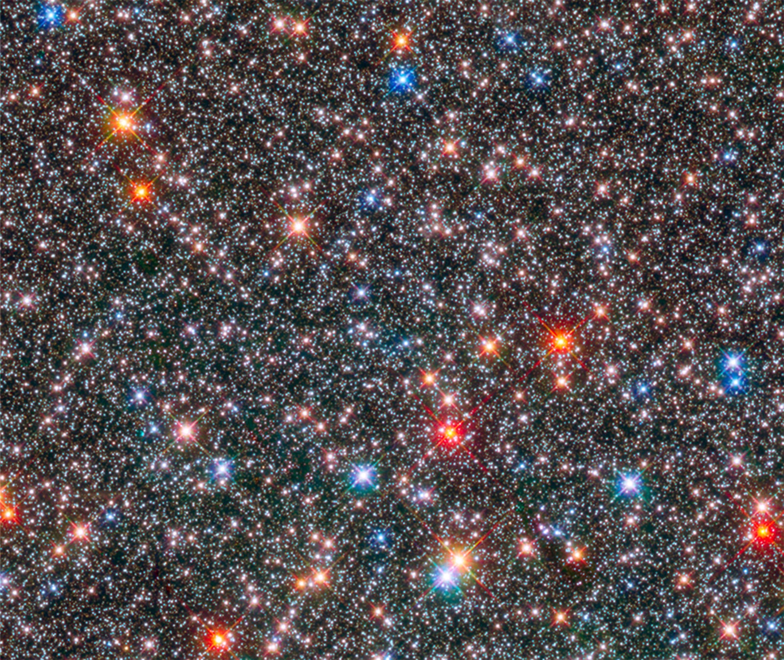 This Hubble Space Telescope image of a sparkling jewel box full of stars captures the heart of our Milky Way galaxy.Aging red giant stars coexist with their more plentiful younger cousins, the smaller, white, Sun-like stars, in this crowded region of our galaxy’s ancient central hub, or bulge. Most of the bright blue stars in the image are probably recently formed stars located in the foreground, in the galaxy's disk. Astronomers studied 10,000 of these Sun-like stars in archival Hubble images over a nine-year period to unearth clues to our galaxy’s evolution. PHOTO COURTESY OF NASA